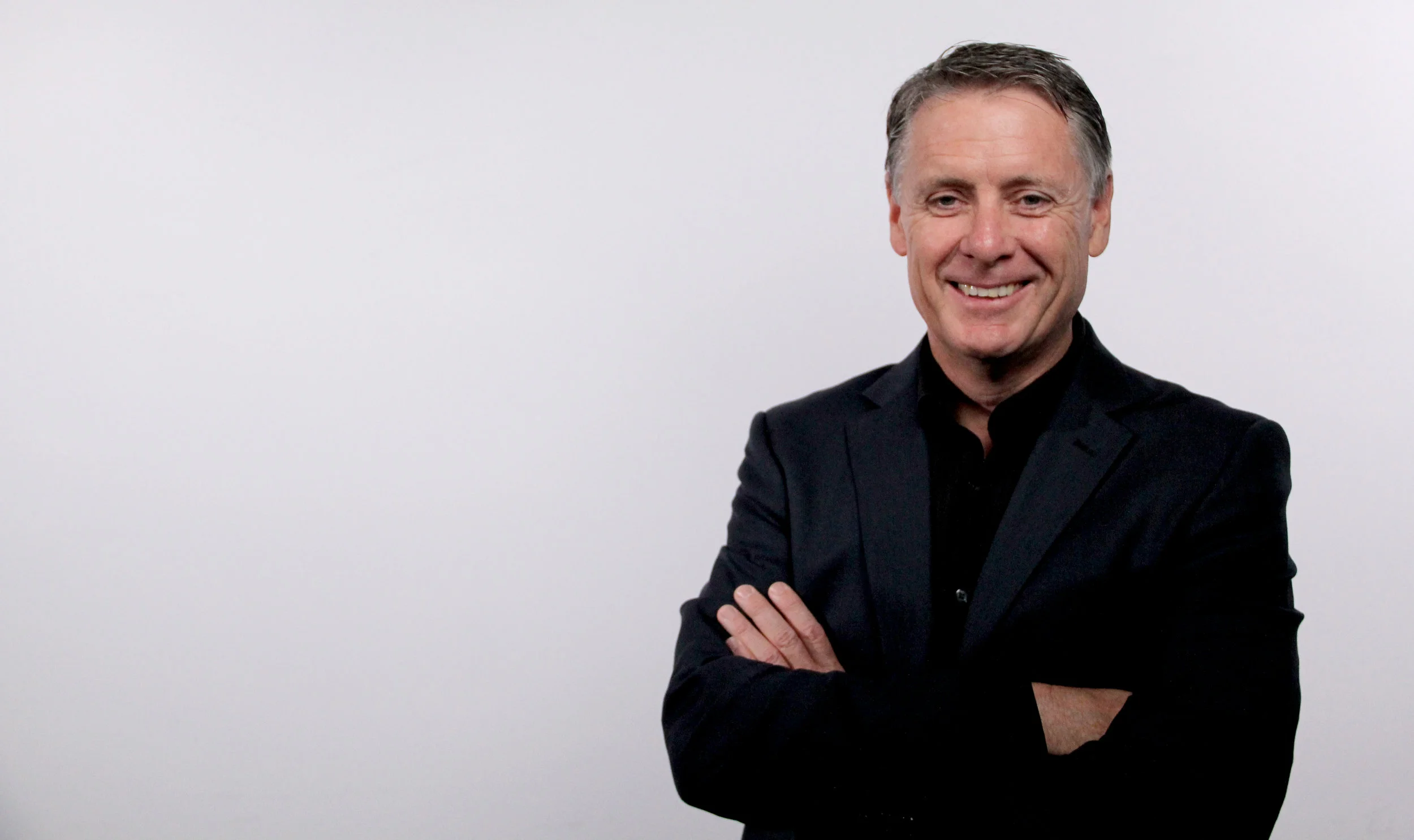 Tony Hughes white background offset and smiling