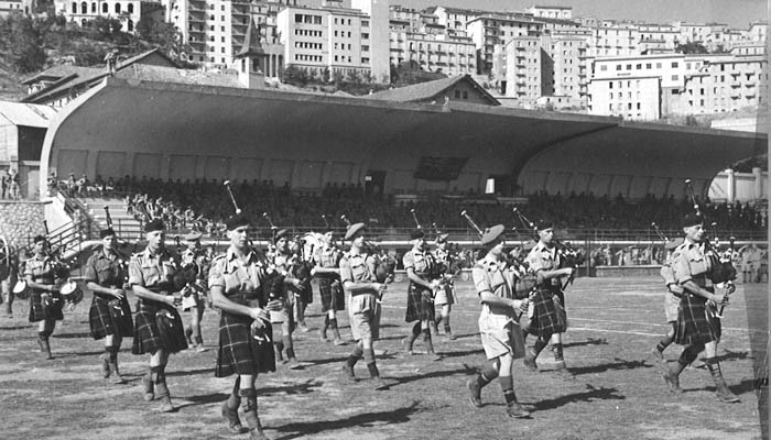  Seaforth Highlanders Pipes and Drums playing in the Stadio Alfredo Viviani (opened 1934) in Potenza (Basilicata), Italy 1943. 