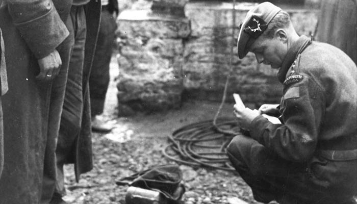  Seaforth Officer, Capt. Keith Murdoch doing an inventory of the effects of German POWs. Possibly in Italy. 
