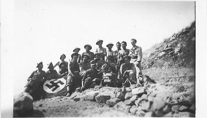 Seaforth A Coy in the Salso Valley, Sicily - August 1943. The Seaforths have posed with the German soldiers that they just captured. Note their MG-34 machine gun and Nazi flag.