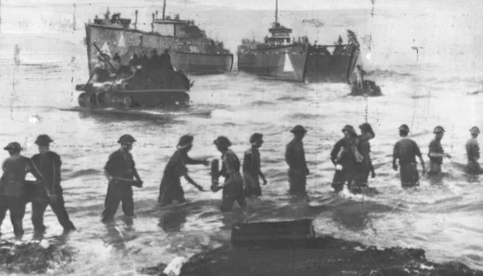 Troops unloading ammunition from ships and landing craft onto the beaches.