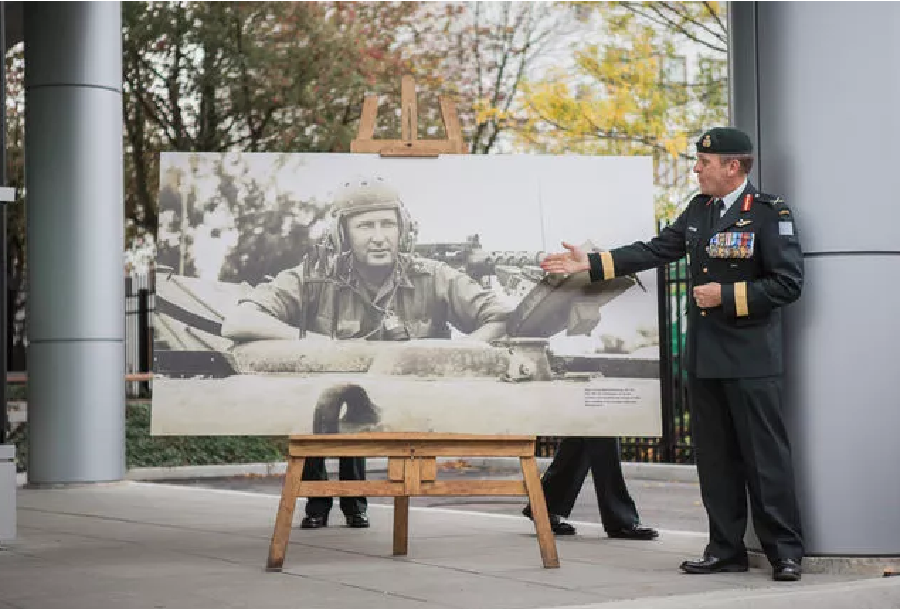 Brigadier-General Simon Hetherington with a portrait of Major-General Bertram Hoffmeister at the ribbon cutting ceremony for the Hoffmeister Building. Bombardier Albert Law, 39 CBG Public Affairs