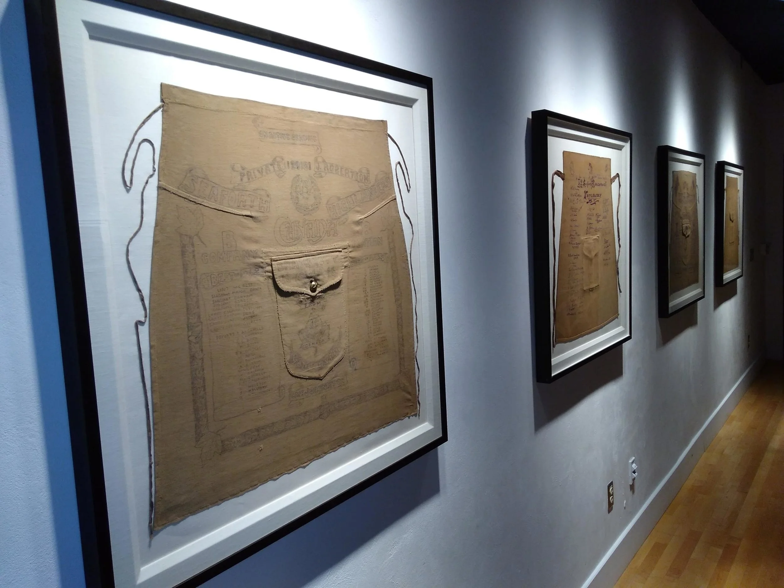 Signed 72nd Battalion kilt aprons on display in the Anderson Room, Seaforth Armoury