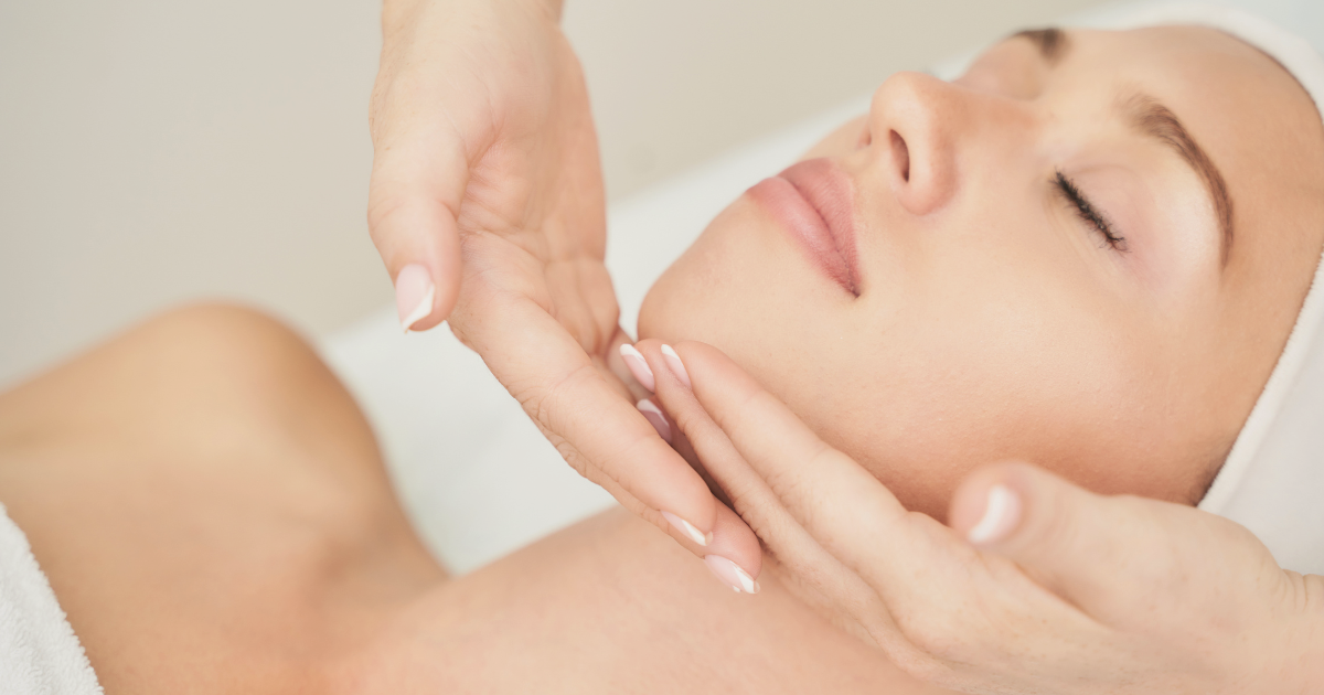 A woman receiving a facial massage at a spa or skincare clinic.