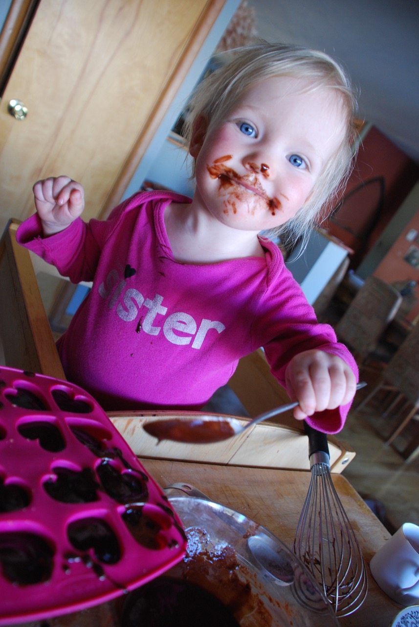 HELPERS: SADIE SPOONS ON CHOCOLATE SAUCE AFTER LICKING THE WHISK. 
