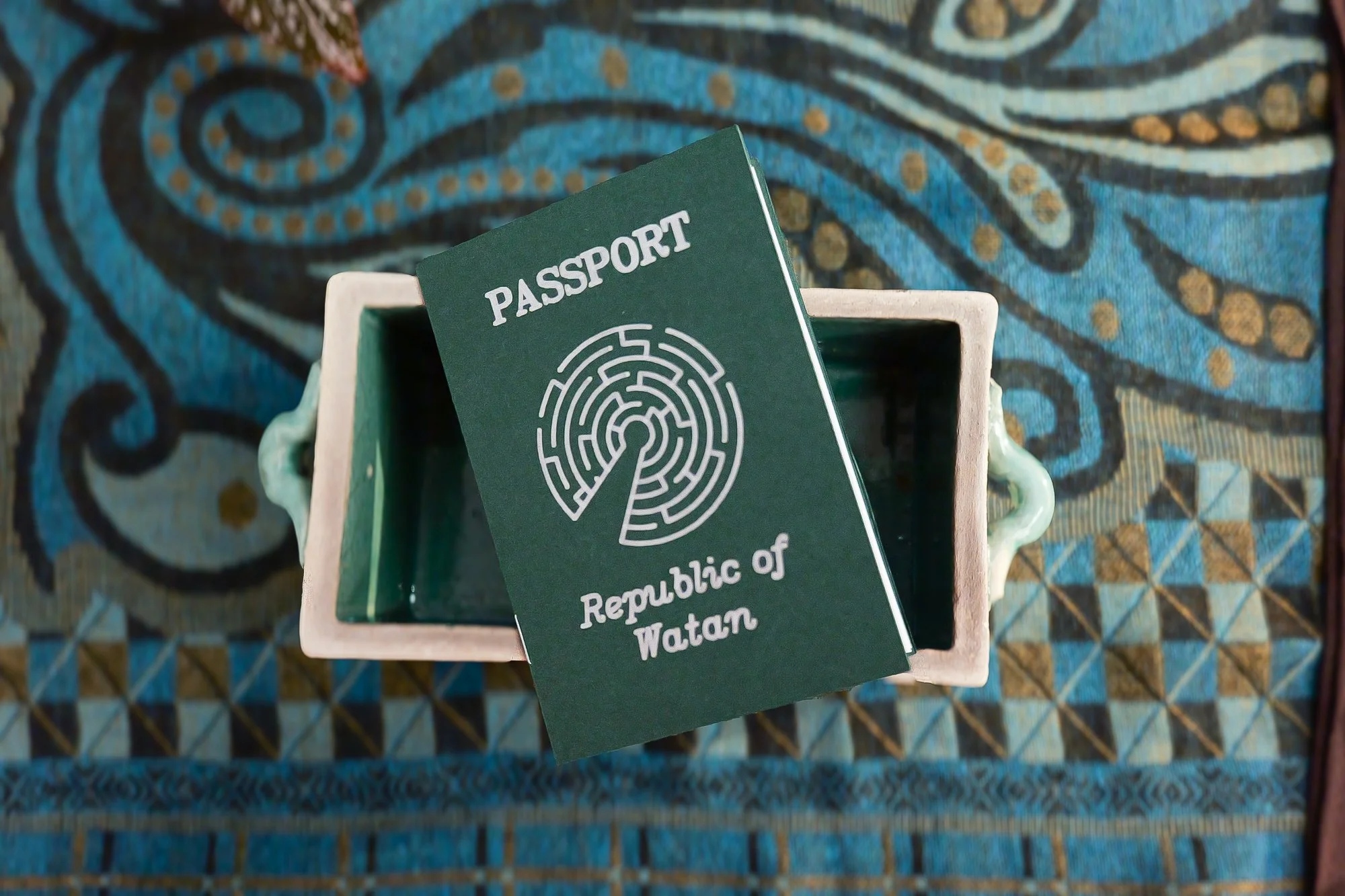  Each player assumed the role of a family member fleeing the fictional country of "Watan," receiving a unique passport with their age, gender, and profession. 