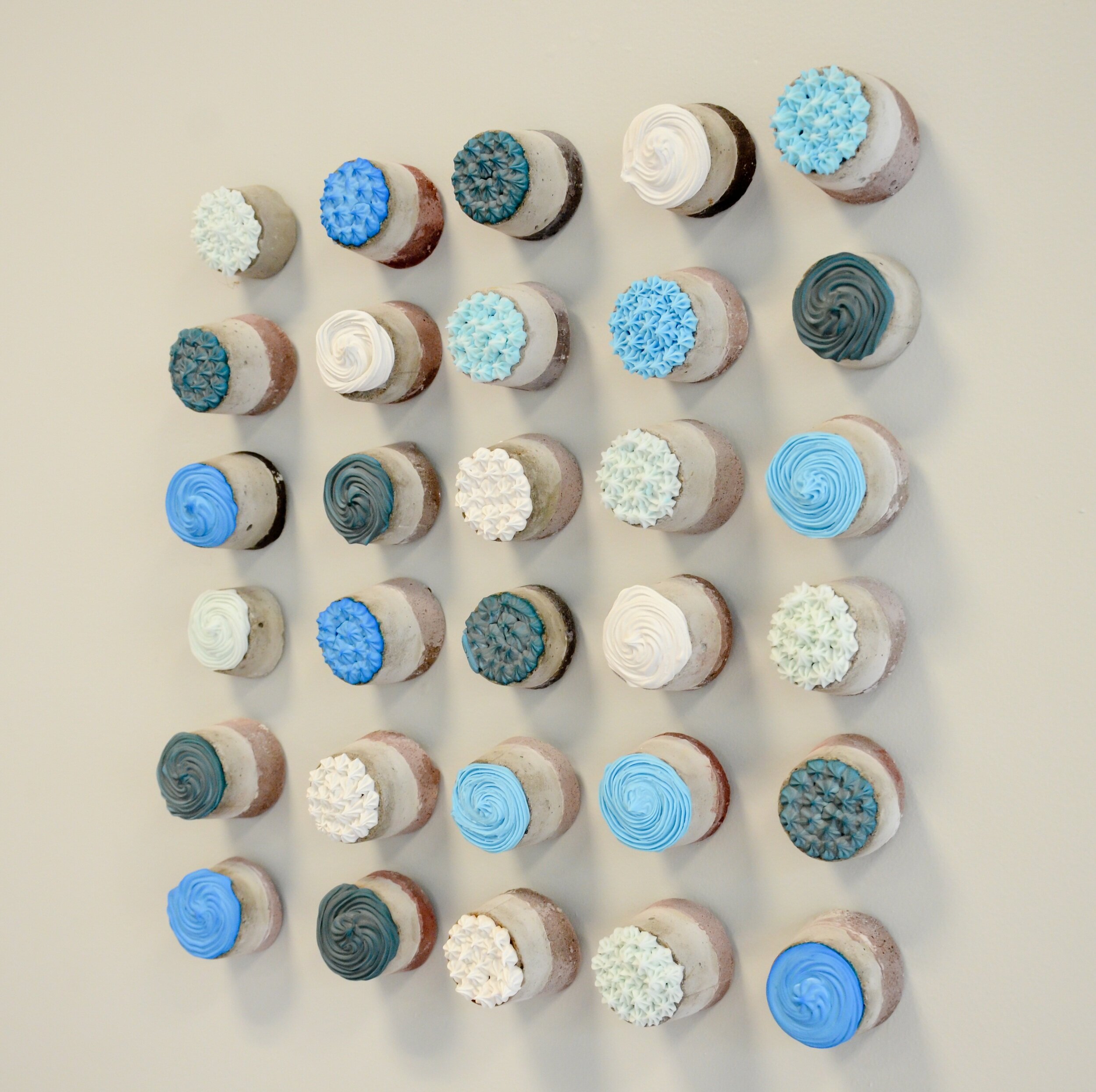   Up in Blue , 2018 Cast cement, buttercream frosting, dimensions variable: shown 18x16x3 inches 