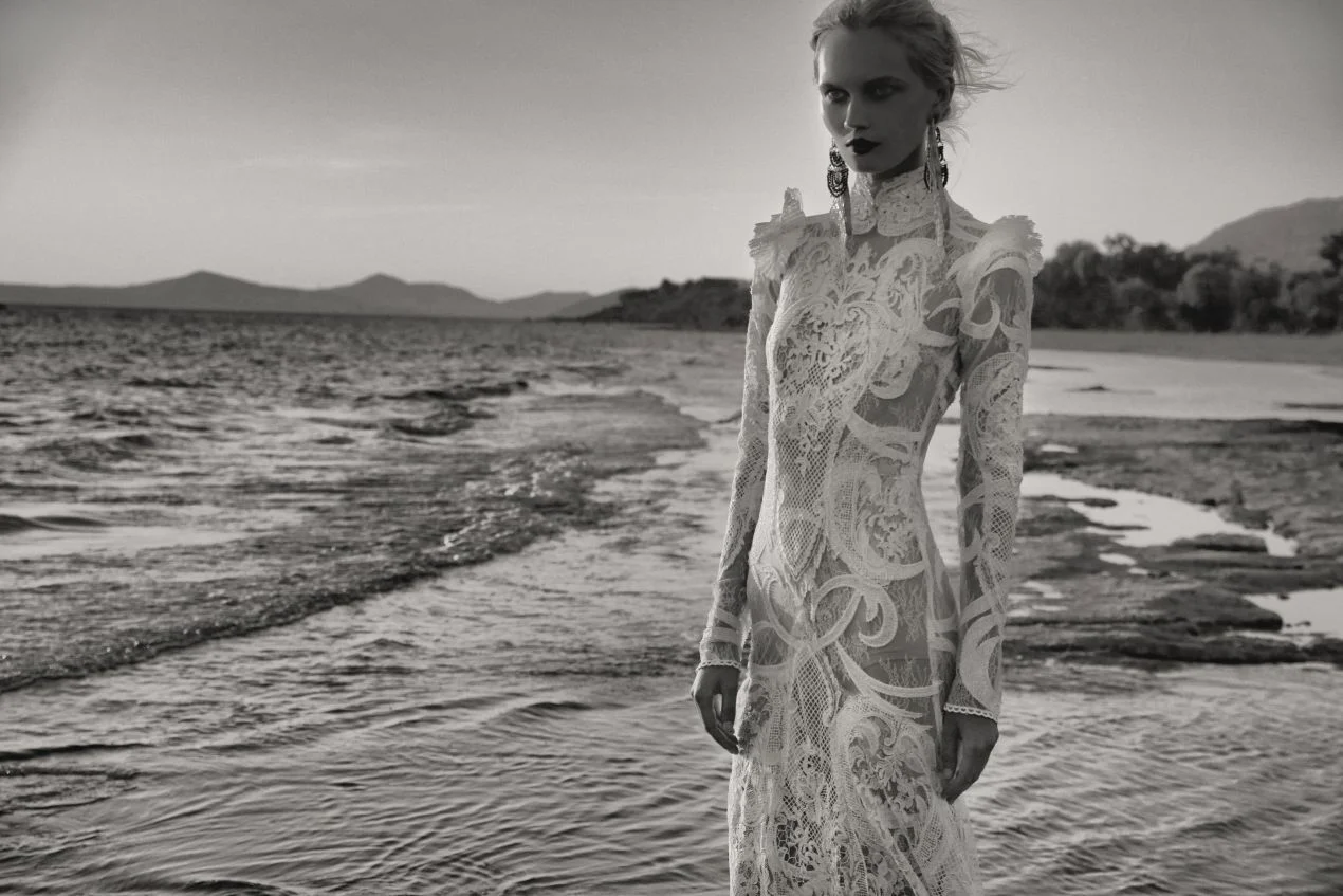 COSTARELLOS LAYERS A MIX OF LACE- EMBROIDERED CHANTILLY LACE AND GRAPHIC GUIPURE APPLIQUES- WITH SHEER NET DETAILS. COURTESY of COSTARELLOS