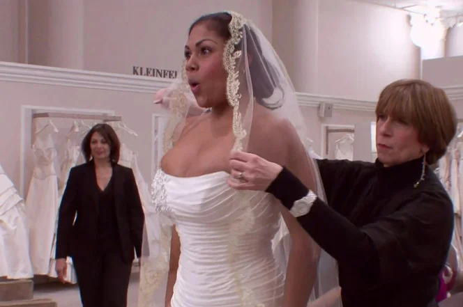 Consultant Sarah Velasquez (center) tries on her dress. TLC