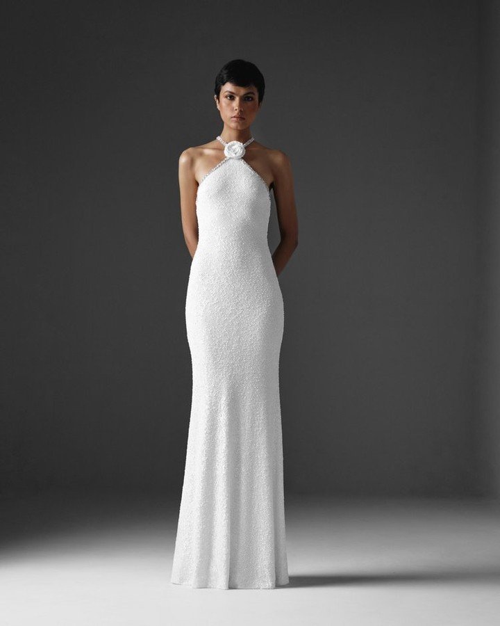 This sequin halter gown, adorned with a rose detail and crystal embroidered straps from @naeemhhannyc Spring 2025 collection is breathtaking.

 #luxurybridal #bridal #SS2025 #Spring2025 #Bridal2025 #trend #trendaleart #2025trend #bridaltrends #weddin