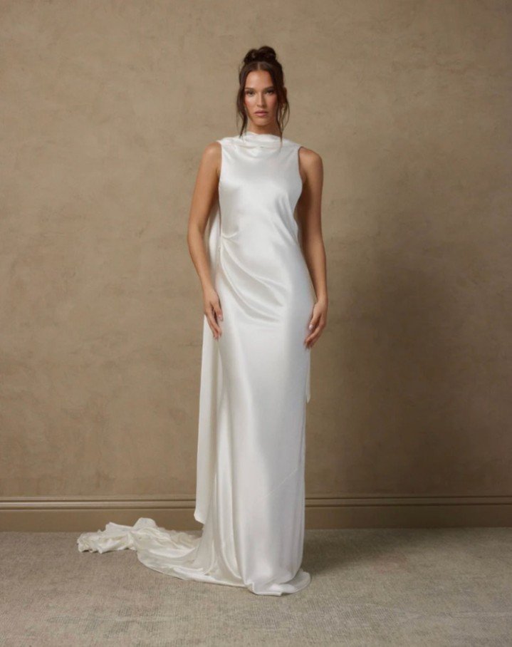 A Silk Crepe gown with an open back and long trailing scarf from the neckline for Katherine Tash Fall 2026 collection. 
#NYLBFW #WeddingInspiration #BridalFashion #WeddingDress #WeddingInspo #BridalInspo #WeddingStyle #RomanticWedding #WeddingPhotogr