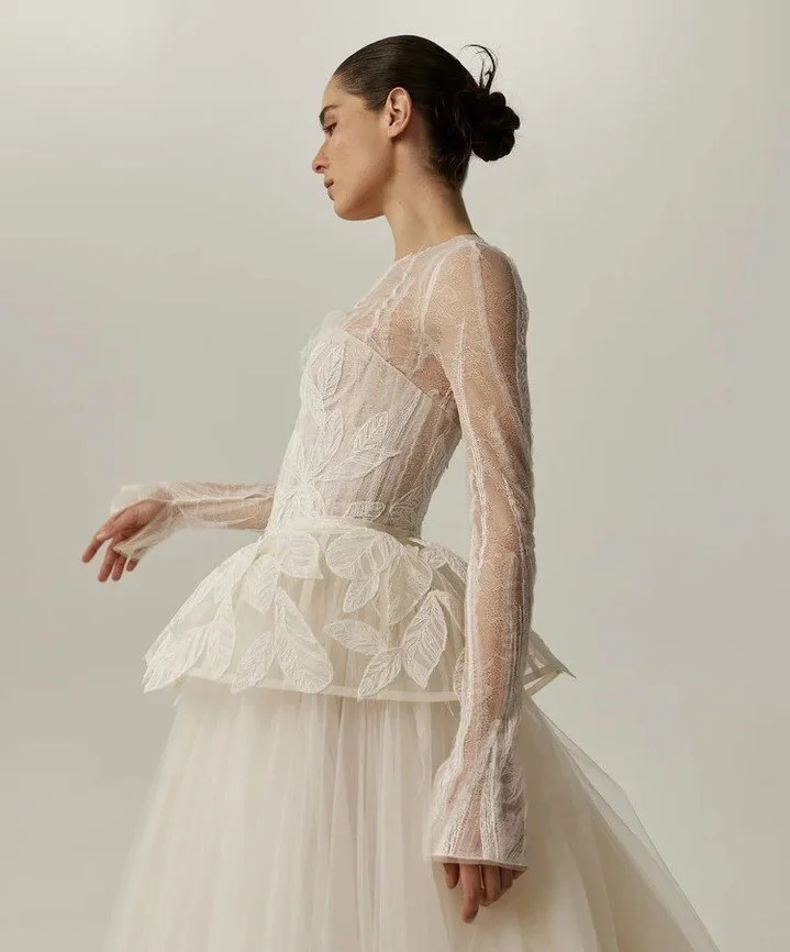 Sheer leafwork and structured gothic sleeves bringing drama to a modern silhouette. @mirazwillinger
#NYLBFW #WeddingInspiration #BridalFashion #WeddingDress #BridalInspo #WeddingStyle #RomanticWedding #WeddingPhotography #BridalStyle #DesignerGown