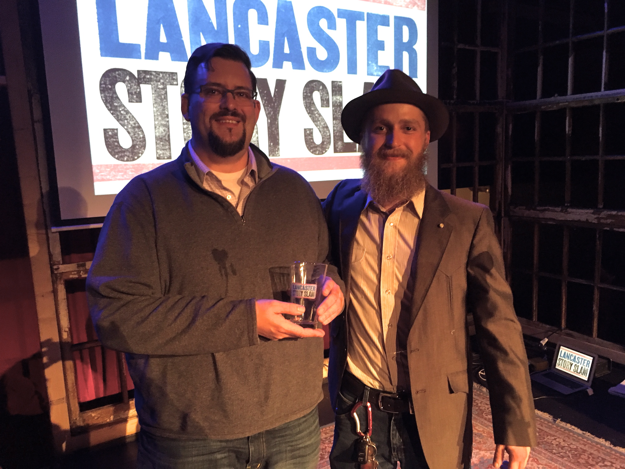 Story Slam winner Matt McDunnell poses with emcee Aaron Lewis