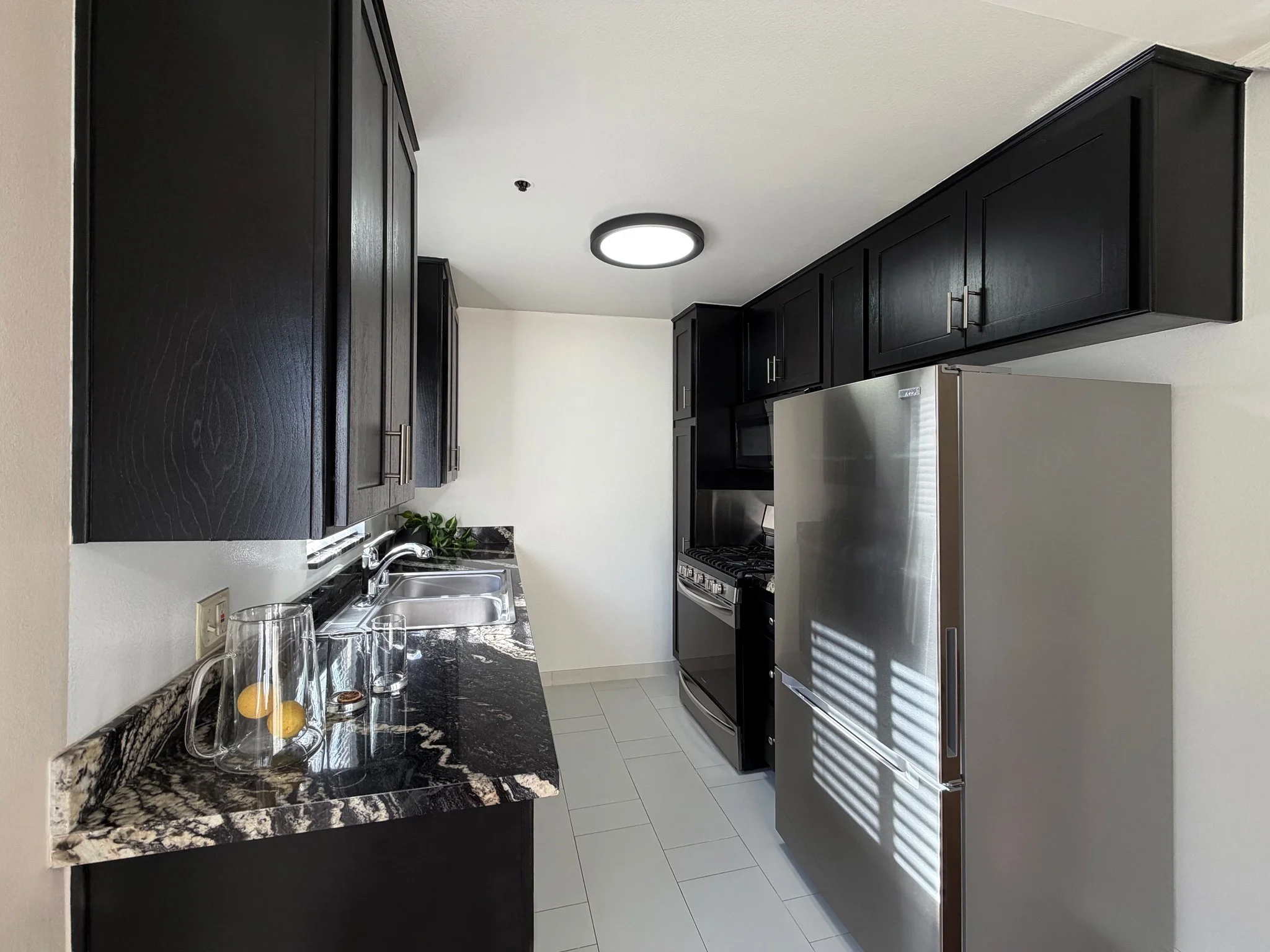   Elegant kitchen with roomy cabinets and BRAND NEW refrigerator  