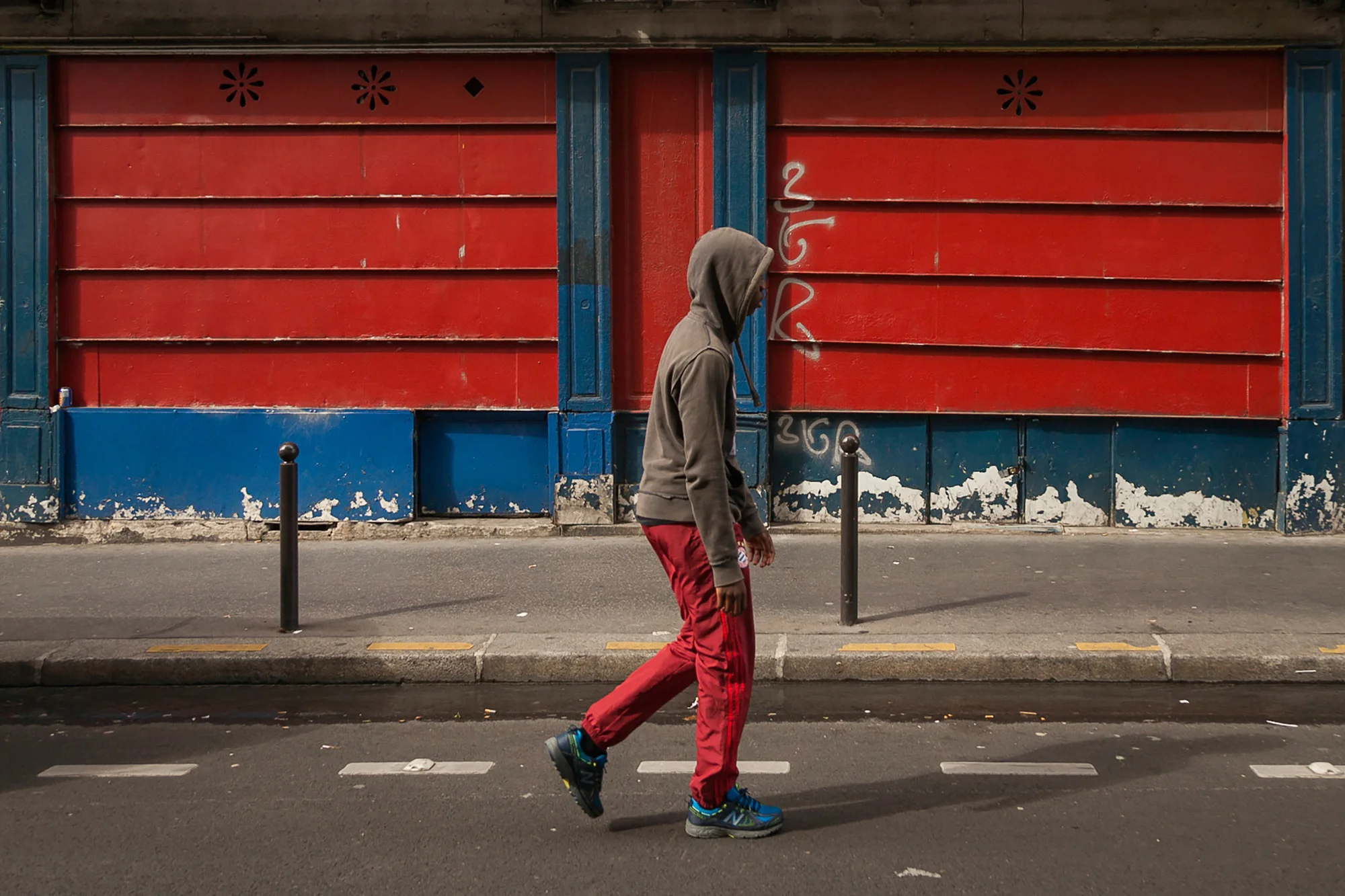 Youngster walks down Rue de Tombouctou.