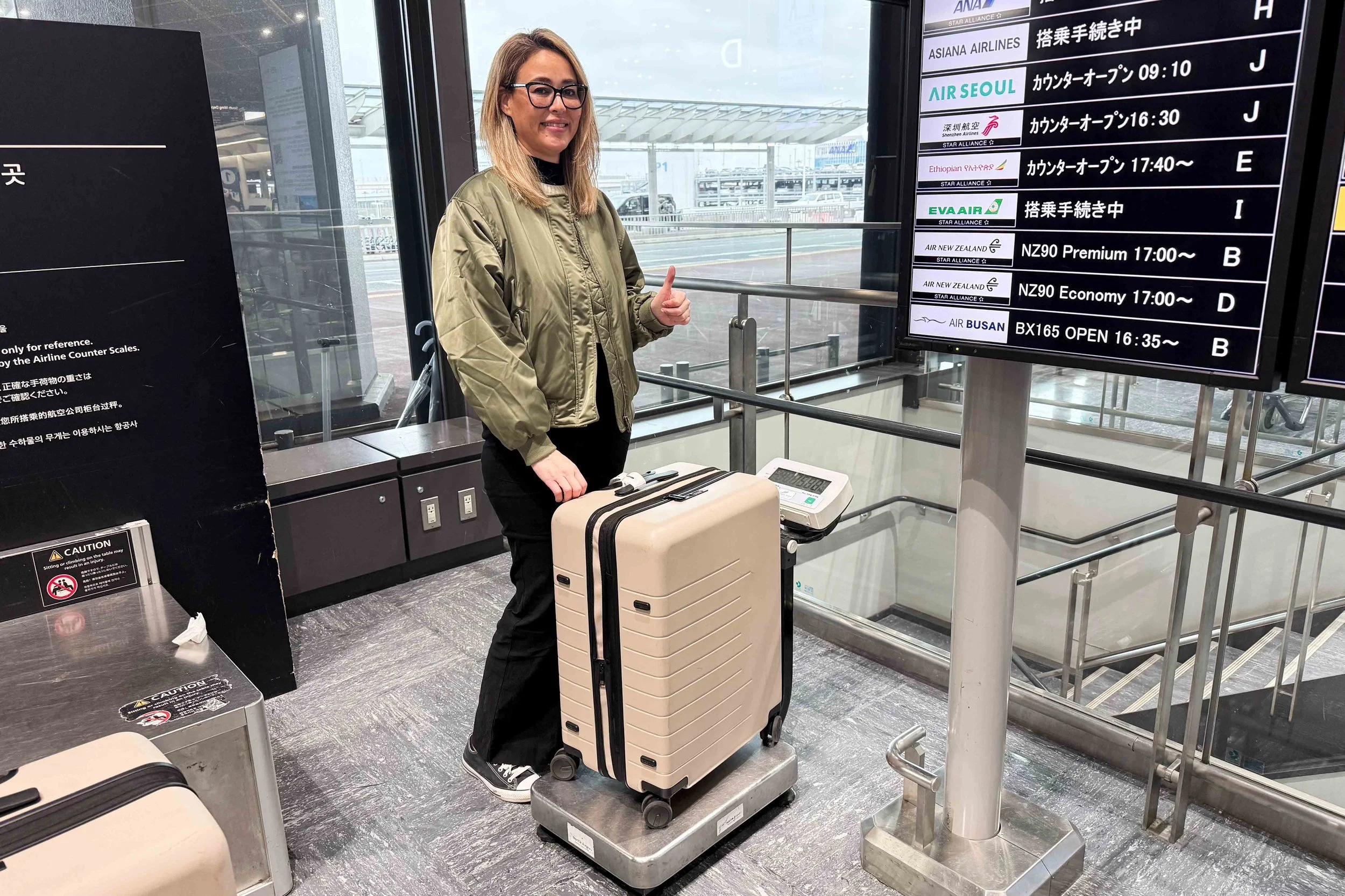 Checking luggage weight on scale at Narita airport