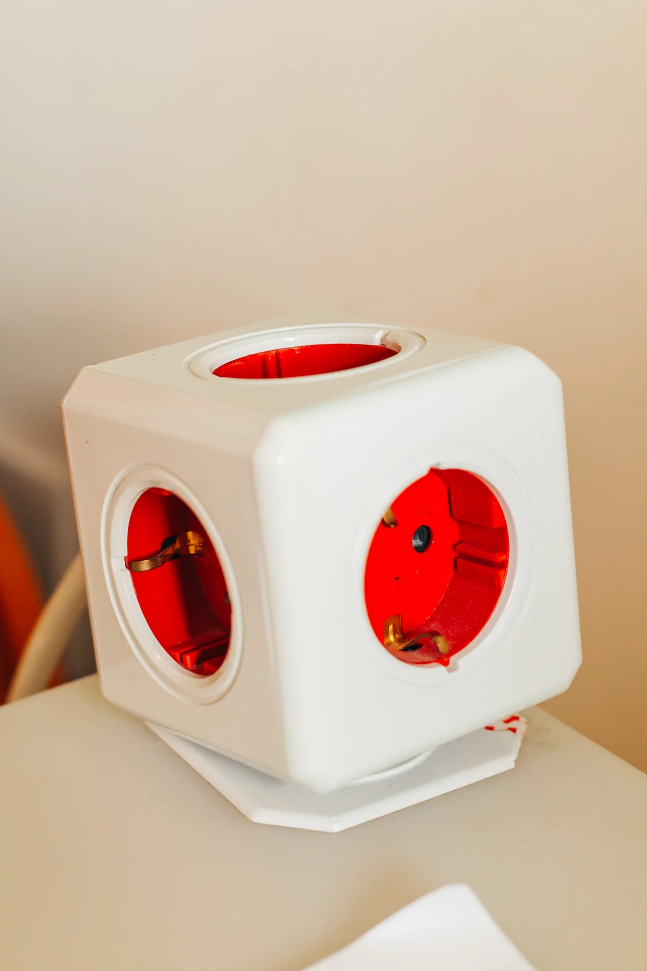 Cool looking cube outlet right next to the bed