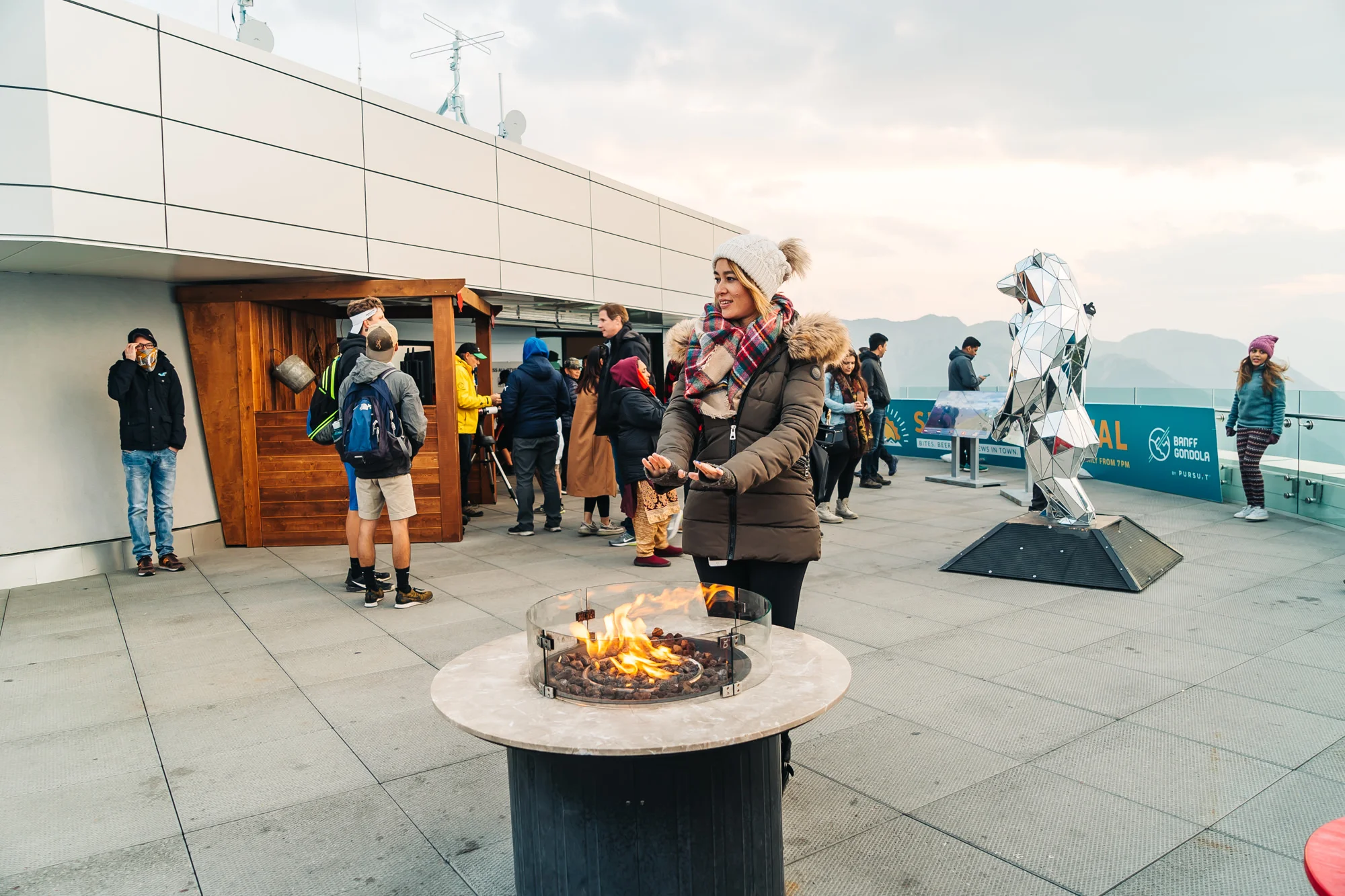 Staying warm at the fire pit on top of Sulphur Mountain
