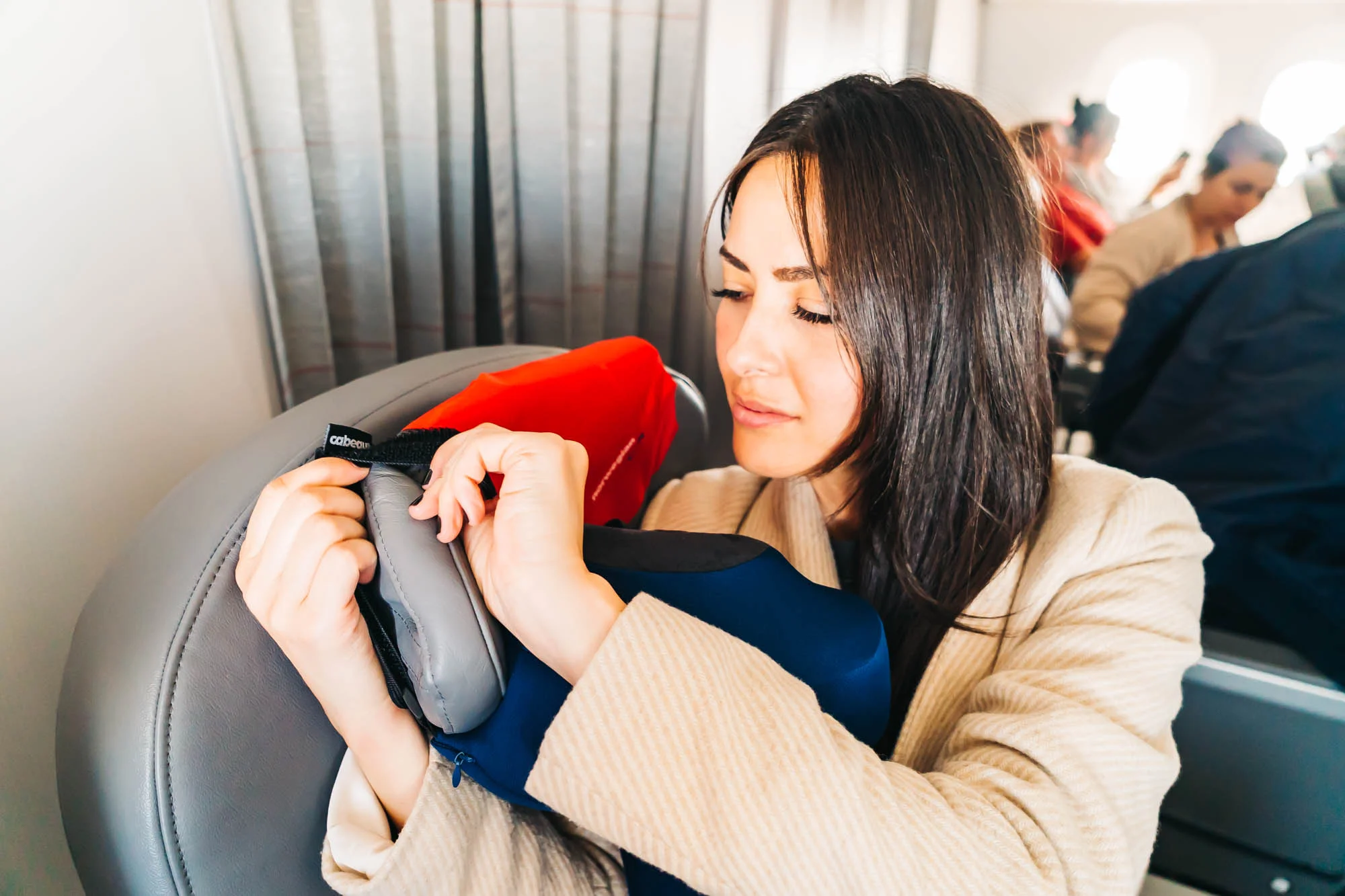 Attaching the pillow to the seat with Cabeau’s Seat Strap System