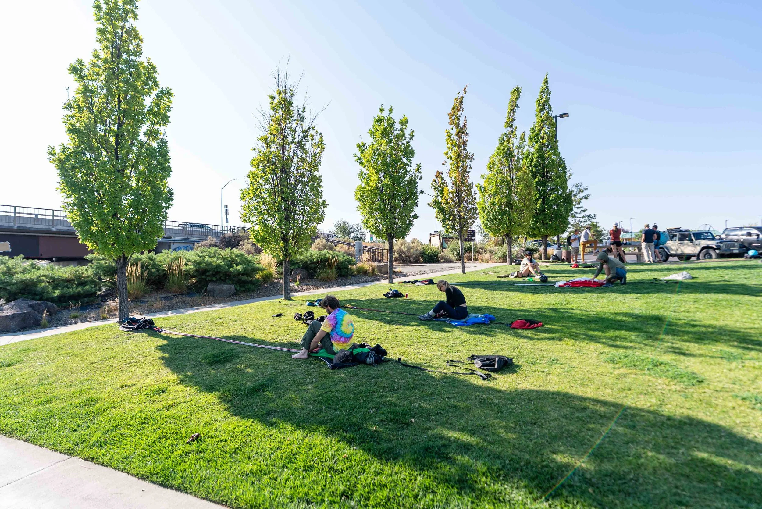 BASE jumpers preparing their parachutes in grass