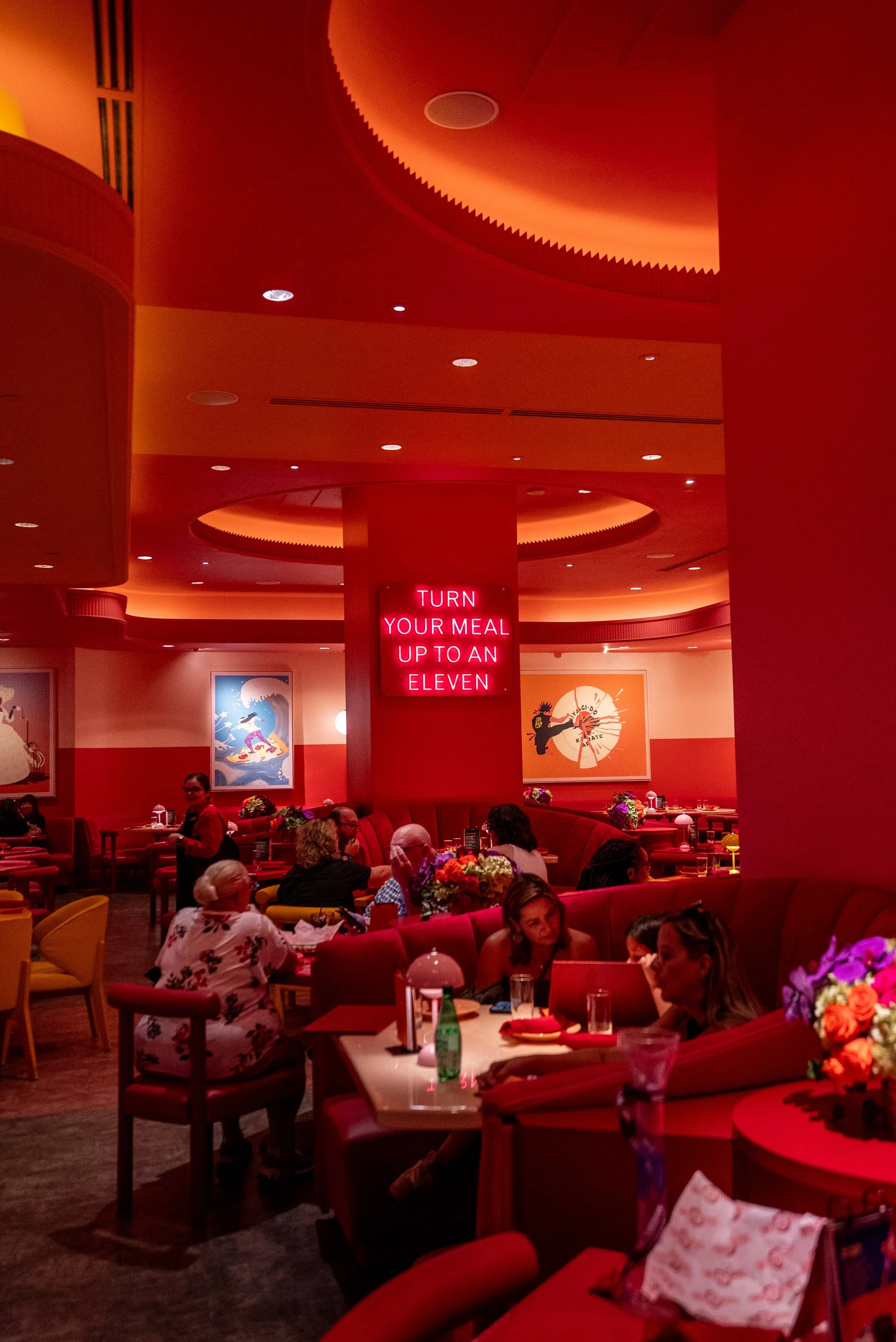 Neon signs and velvet seating in the Netflix Bites dining room