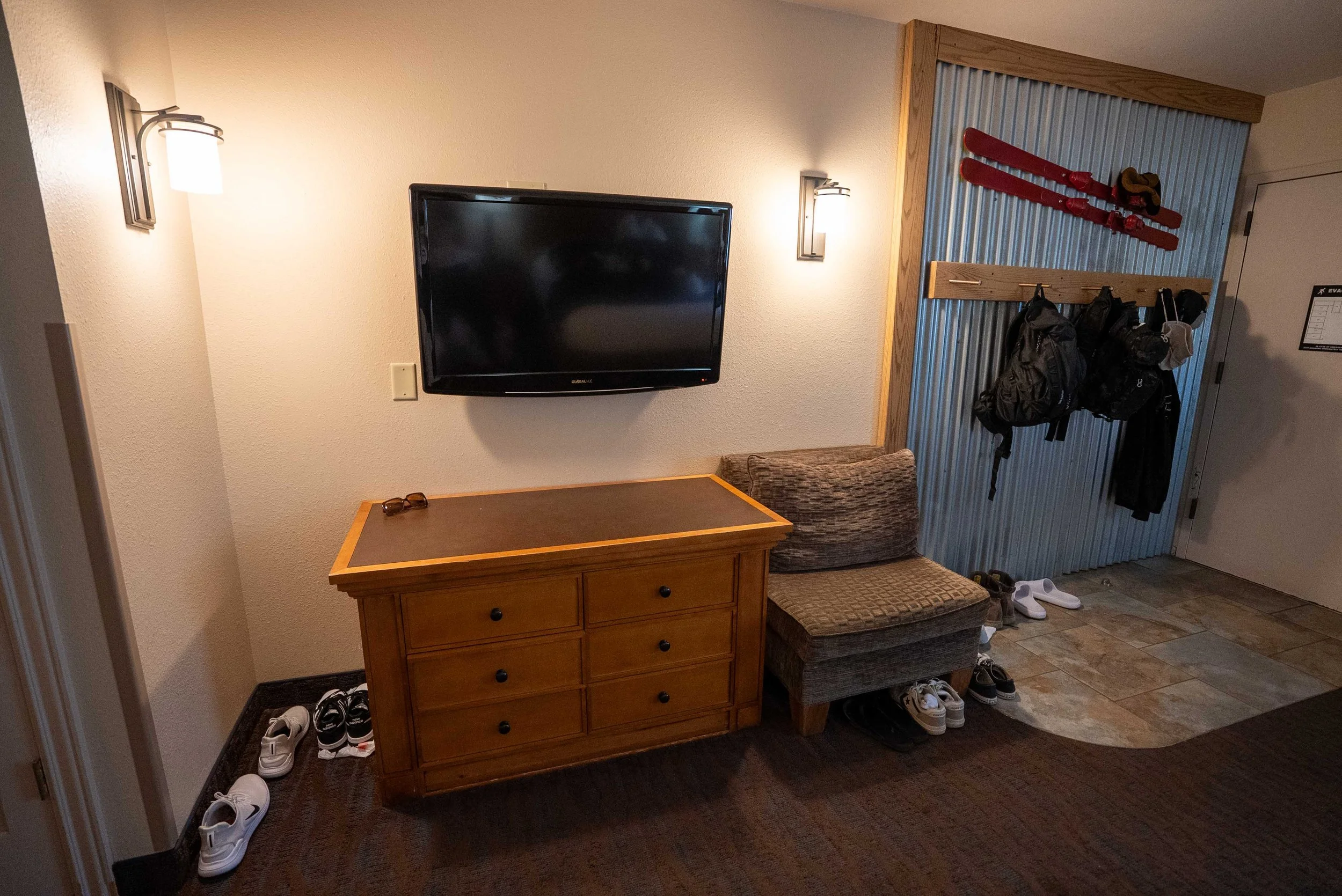 Dresser, chair, TV at Rockwell Inn hotel room