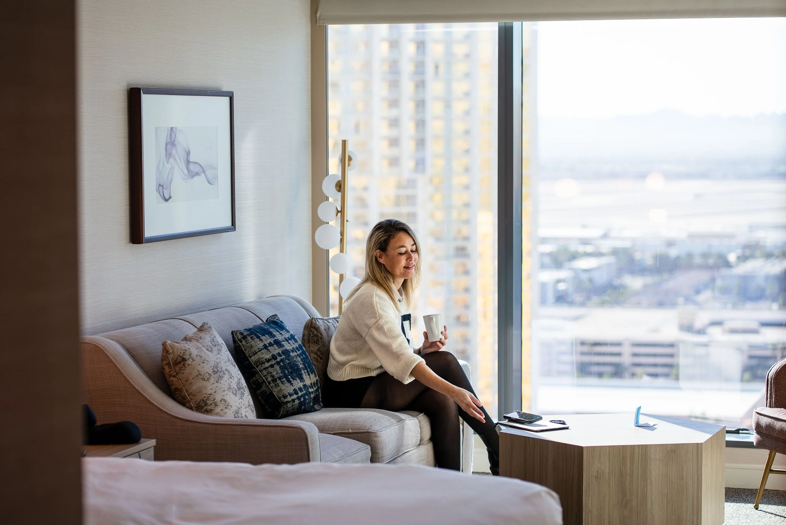 Sitting on the couch in a hotel room in front of a large window
