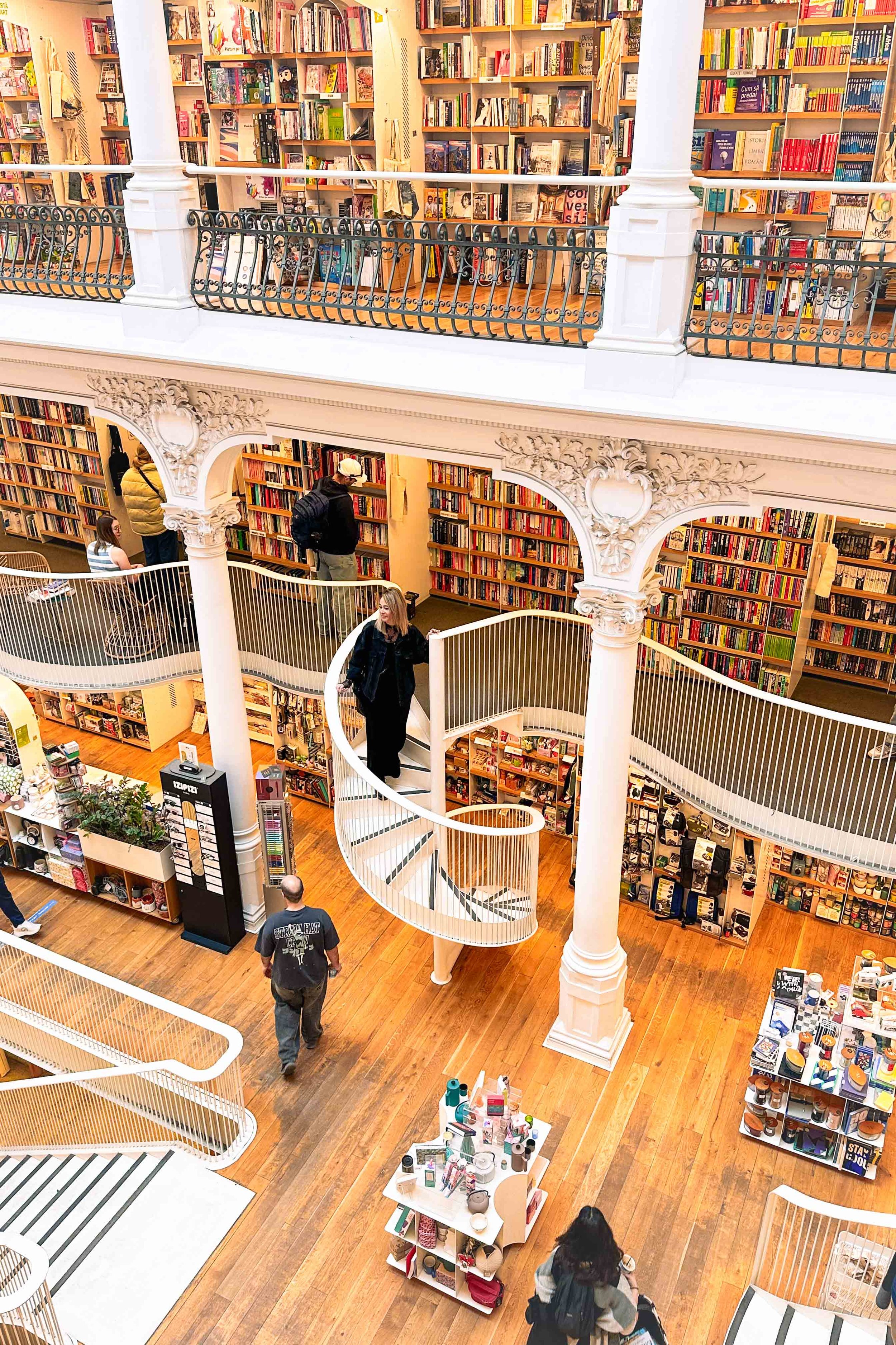 Walking down a curved staircase in a bookstore