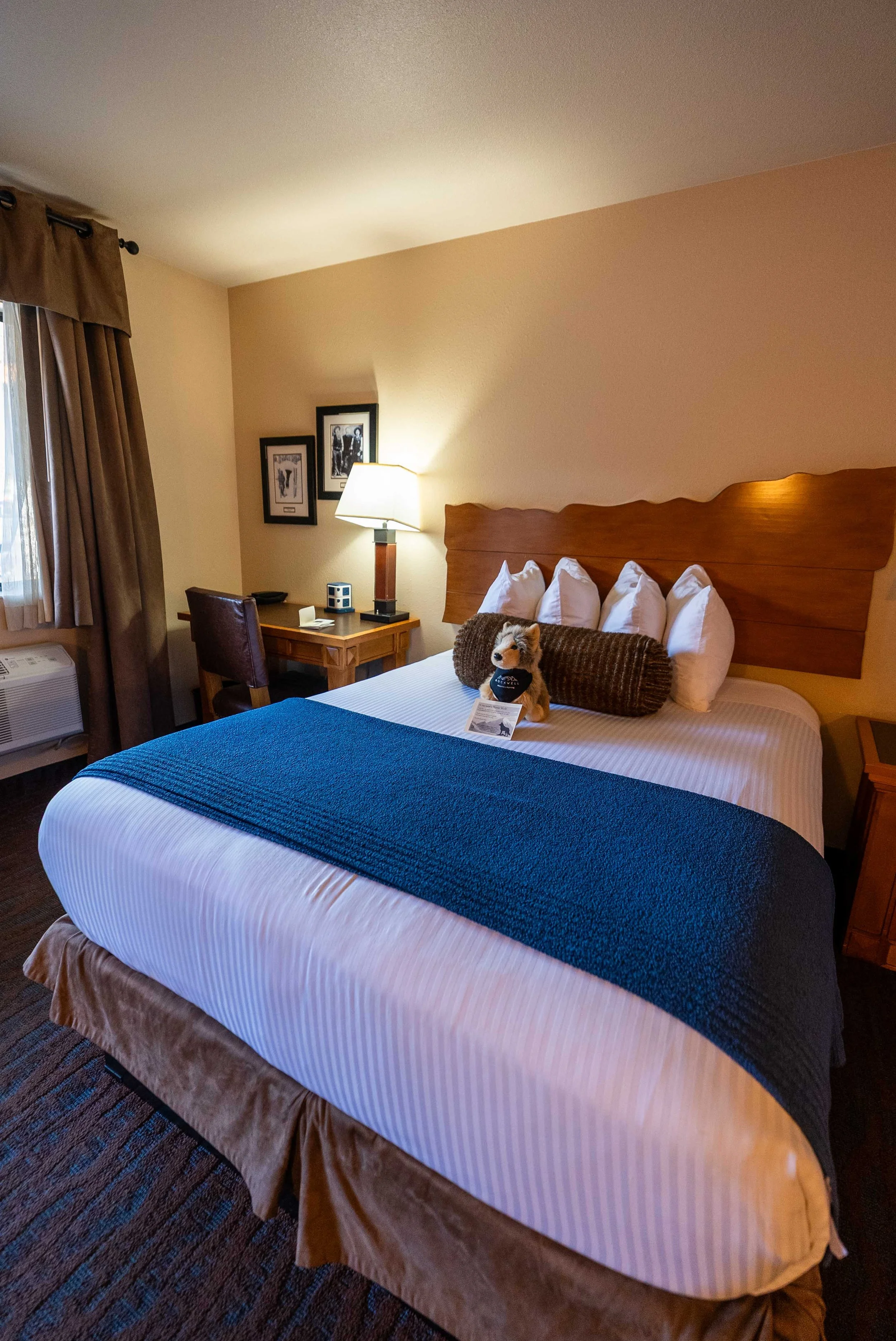 Rockwell Inn hotel room with stuffed animal on bed