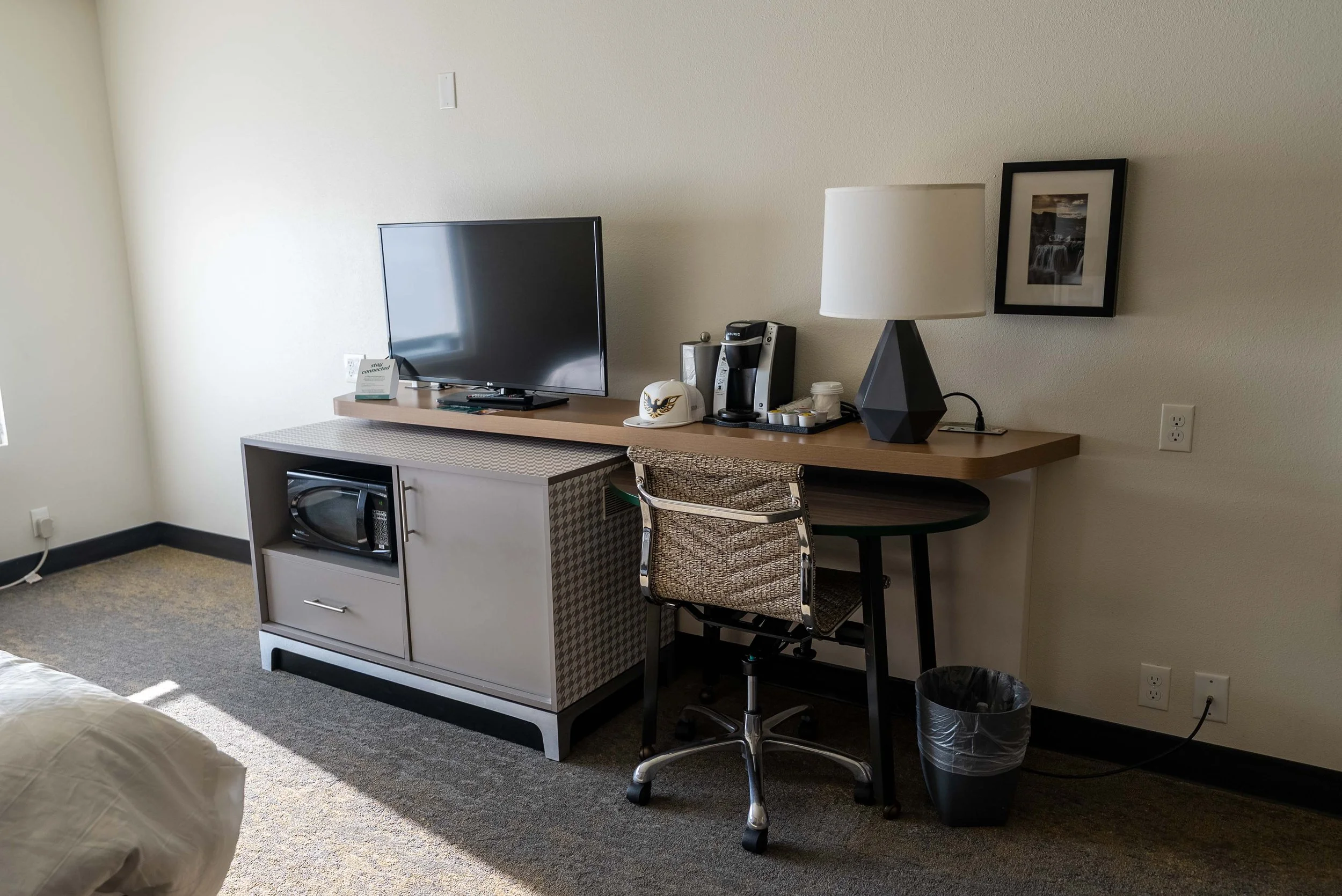 working desk aera with microwave and mini fridge in cabinet