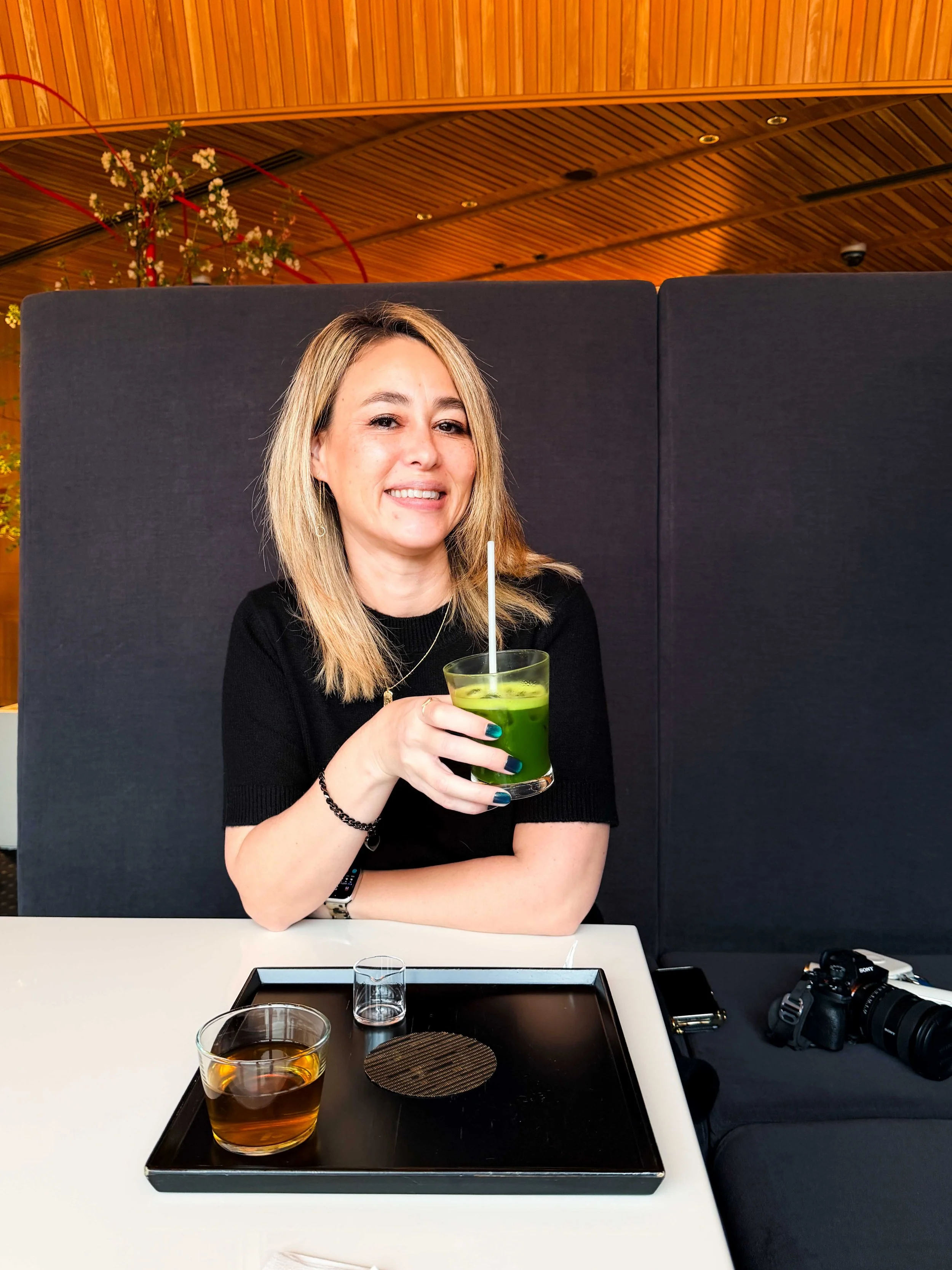 holding a cup of matcha latte