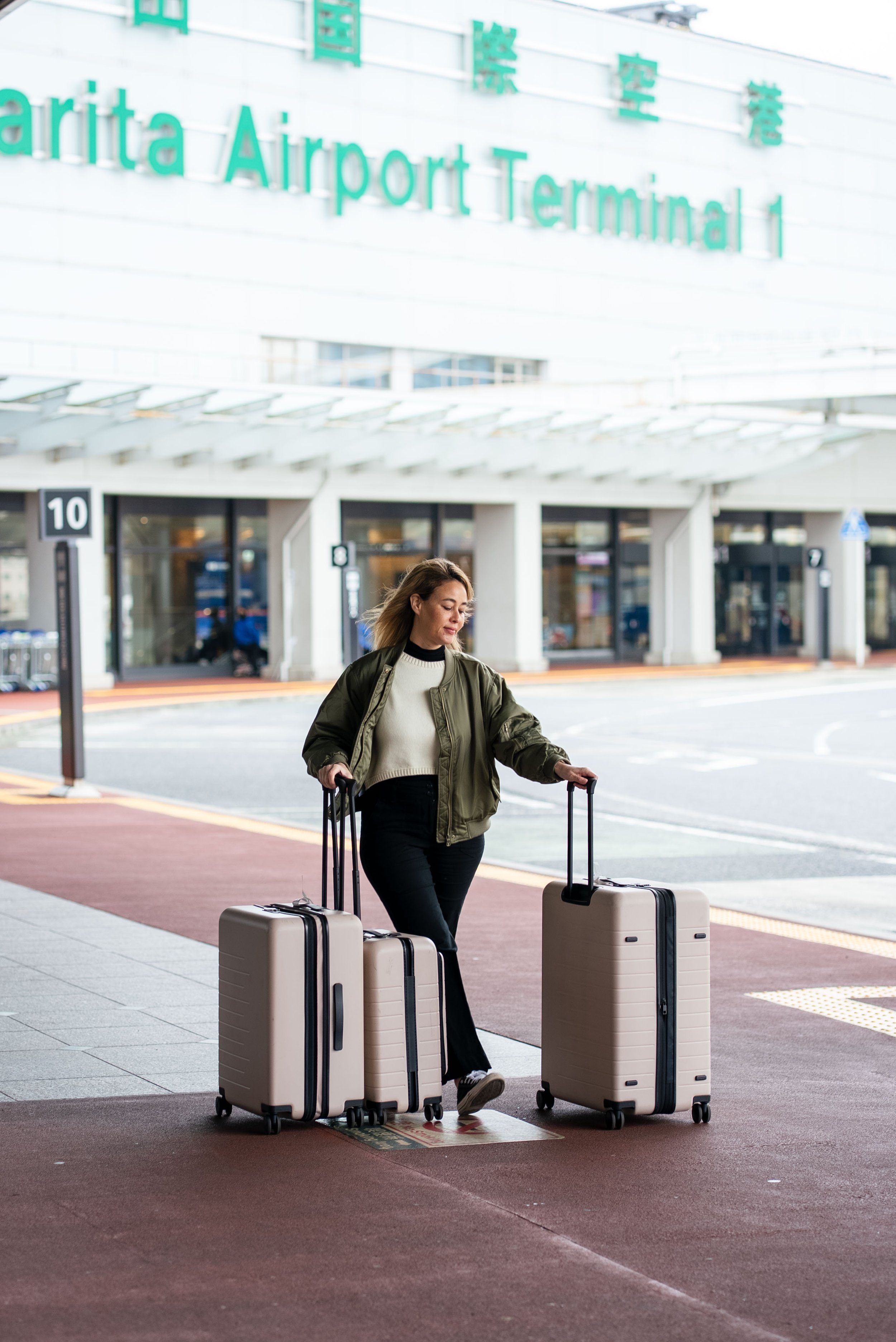 at Narita airport with three Quince suitcases