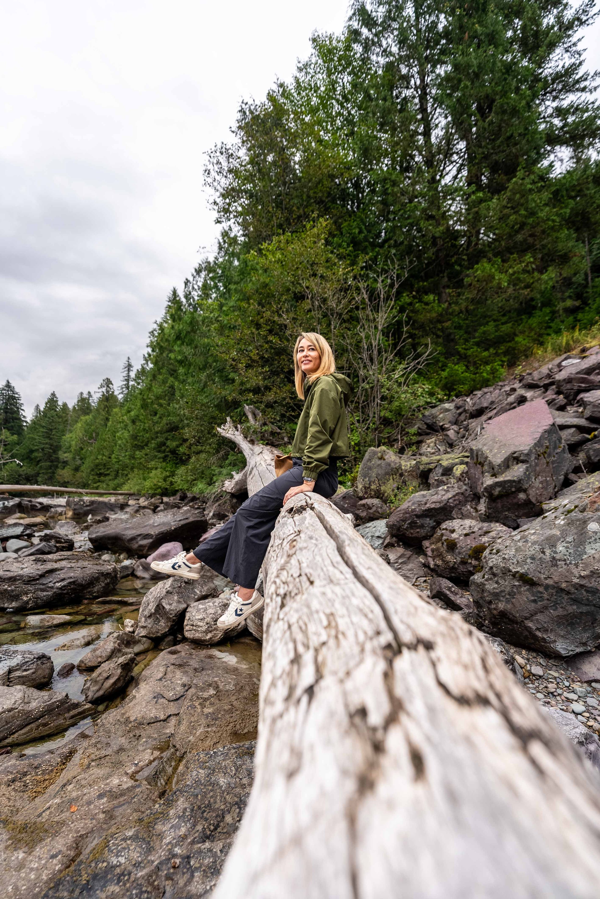Sitting on a long tree trunk at Glacier