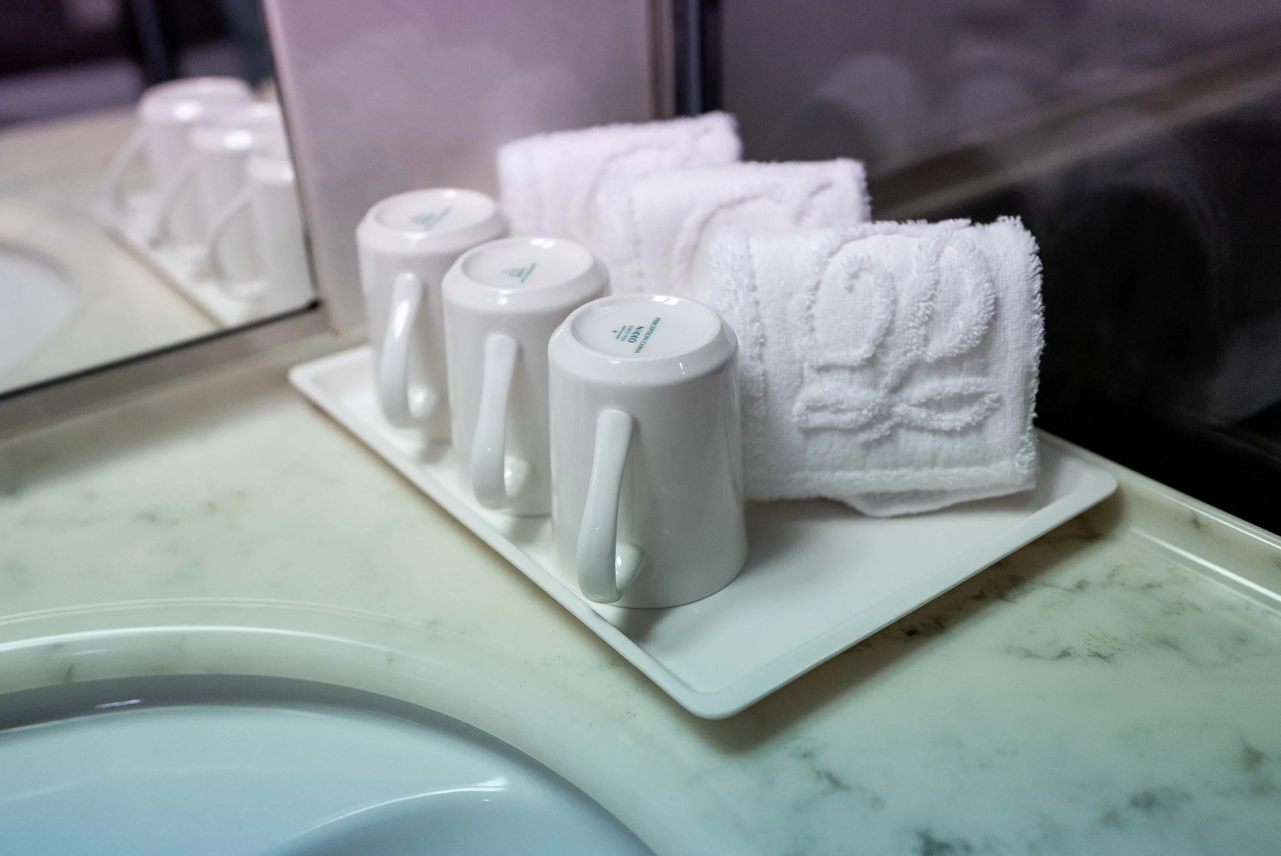 three mugs and towels