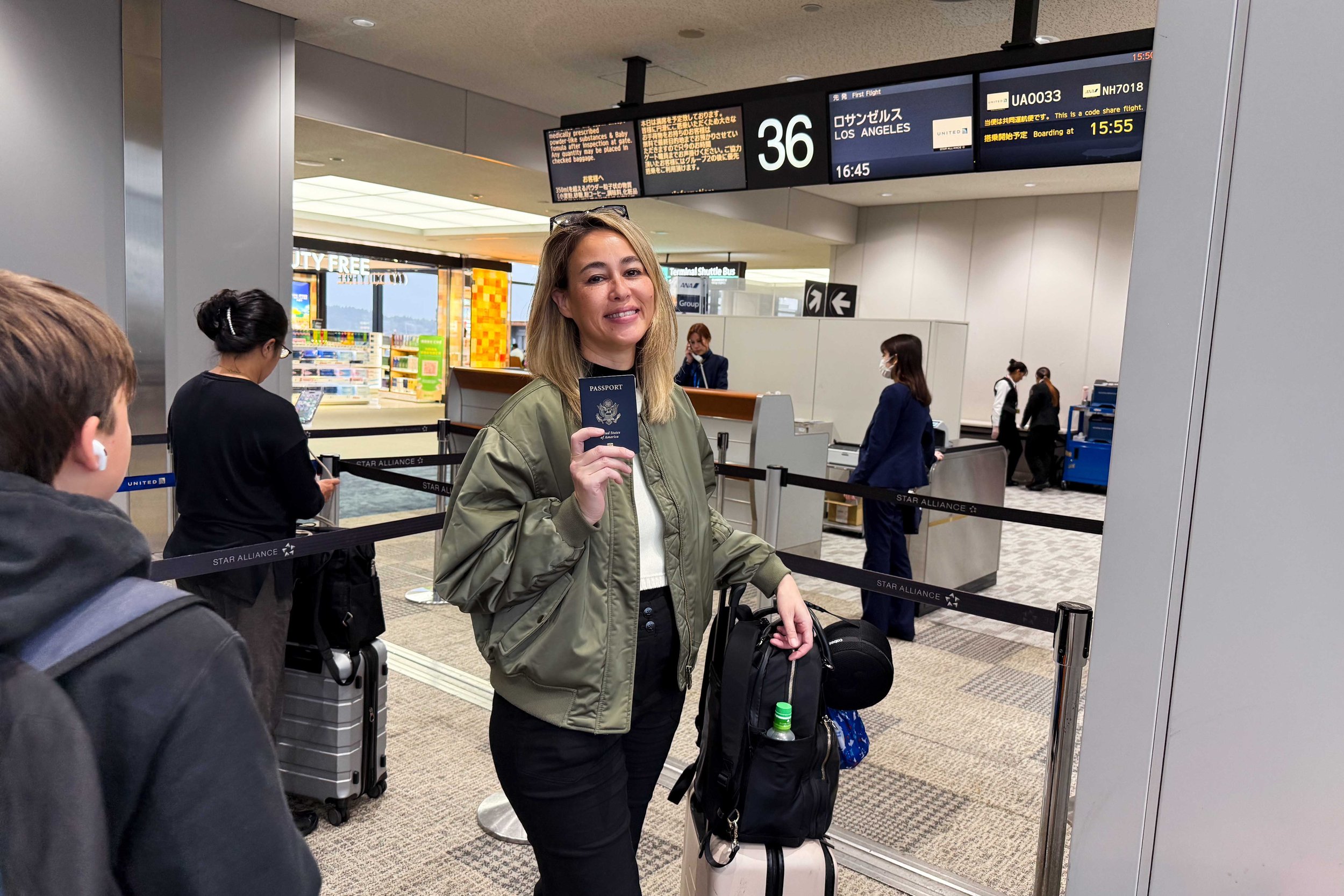 Standing in front of flight gate holding a passport