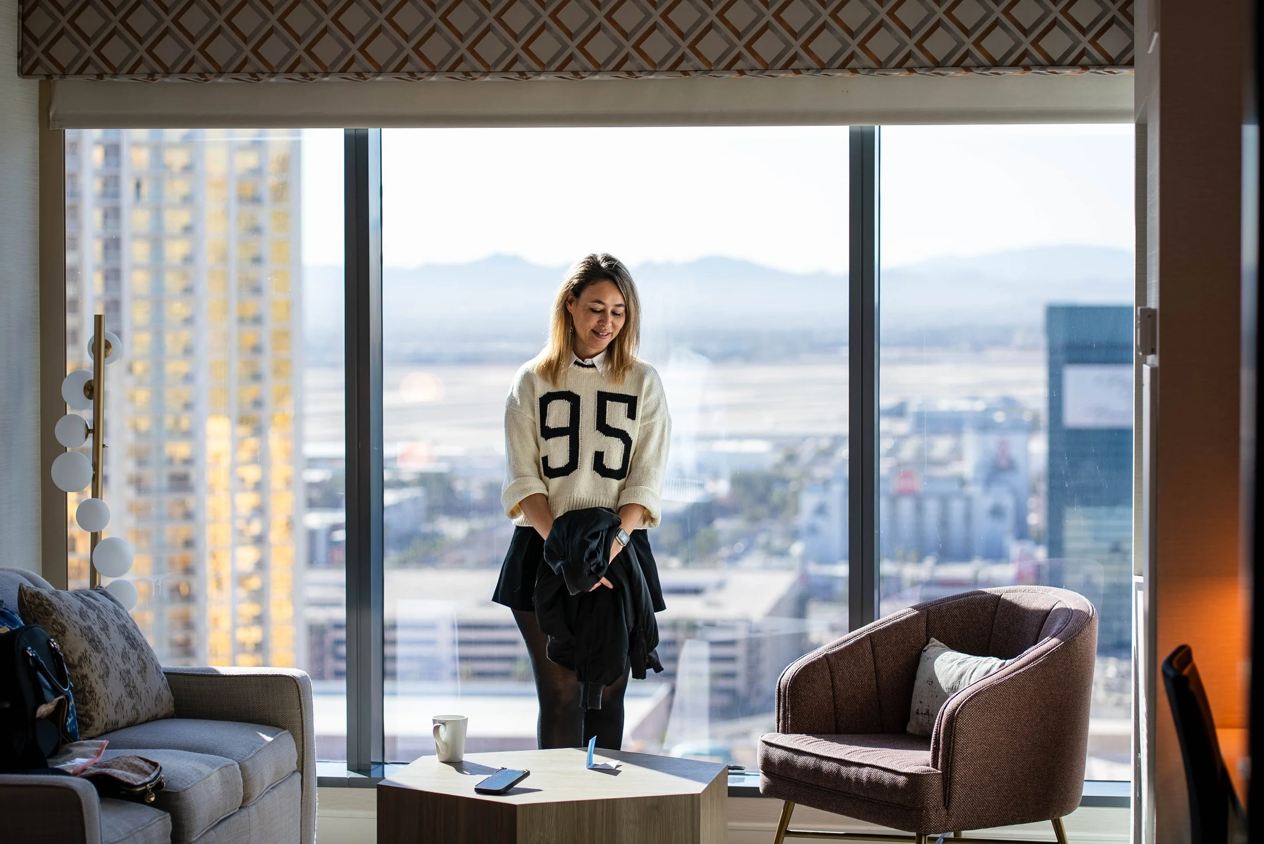 Standing in front of the hotel room window with a view