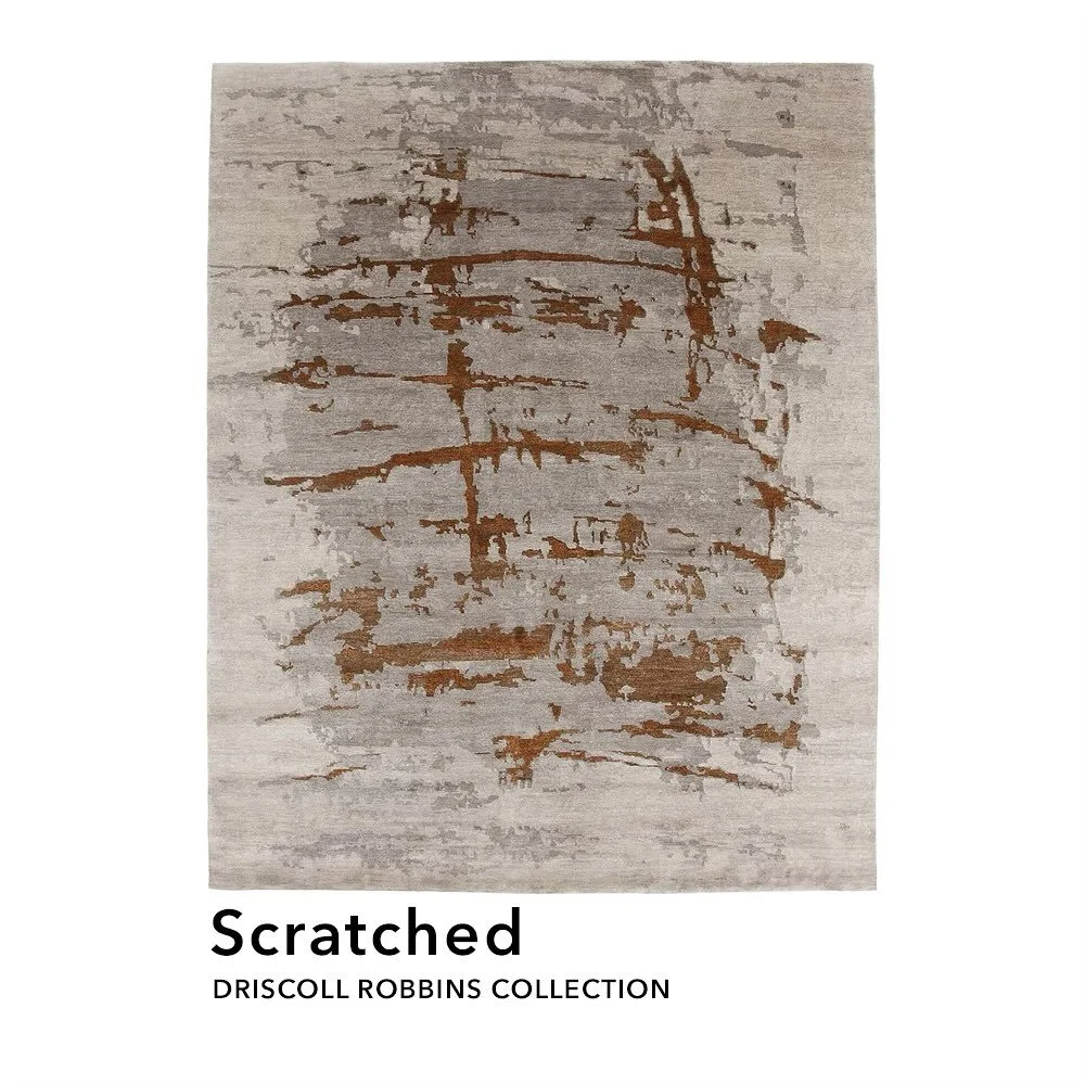 The visuals of gashes etched into a rug's pattern. A contemporary rugged aesthetic that evokes emotions of imperfections and frays on a somber backdrop spreading across the floor.