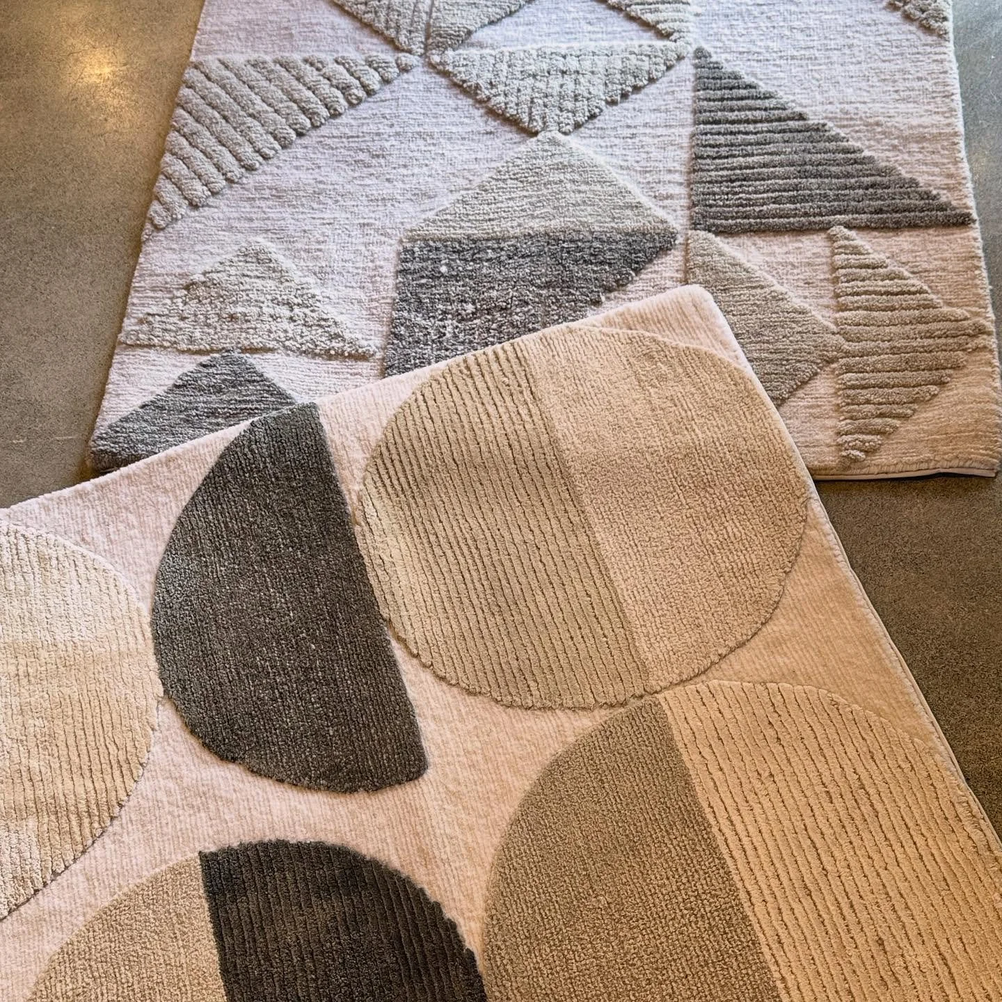 Circles or Triangles? These design samples are repeating shape patterns on rugs available here at our showroom.