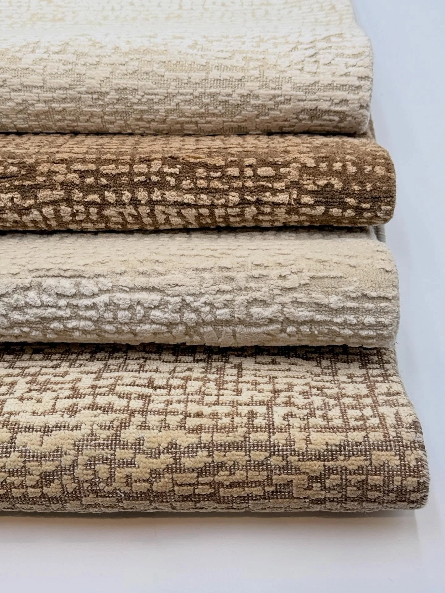 The Gazelle design features 2 colors and 2 unique wool textures. One combines high pile wool and silk, while the other is oxidized for a flat finish. Both options are fantastic, visit our showroom to explore.