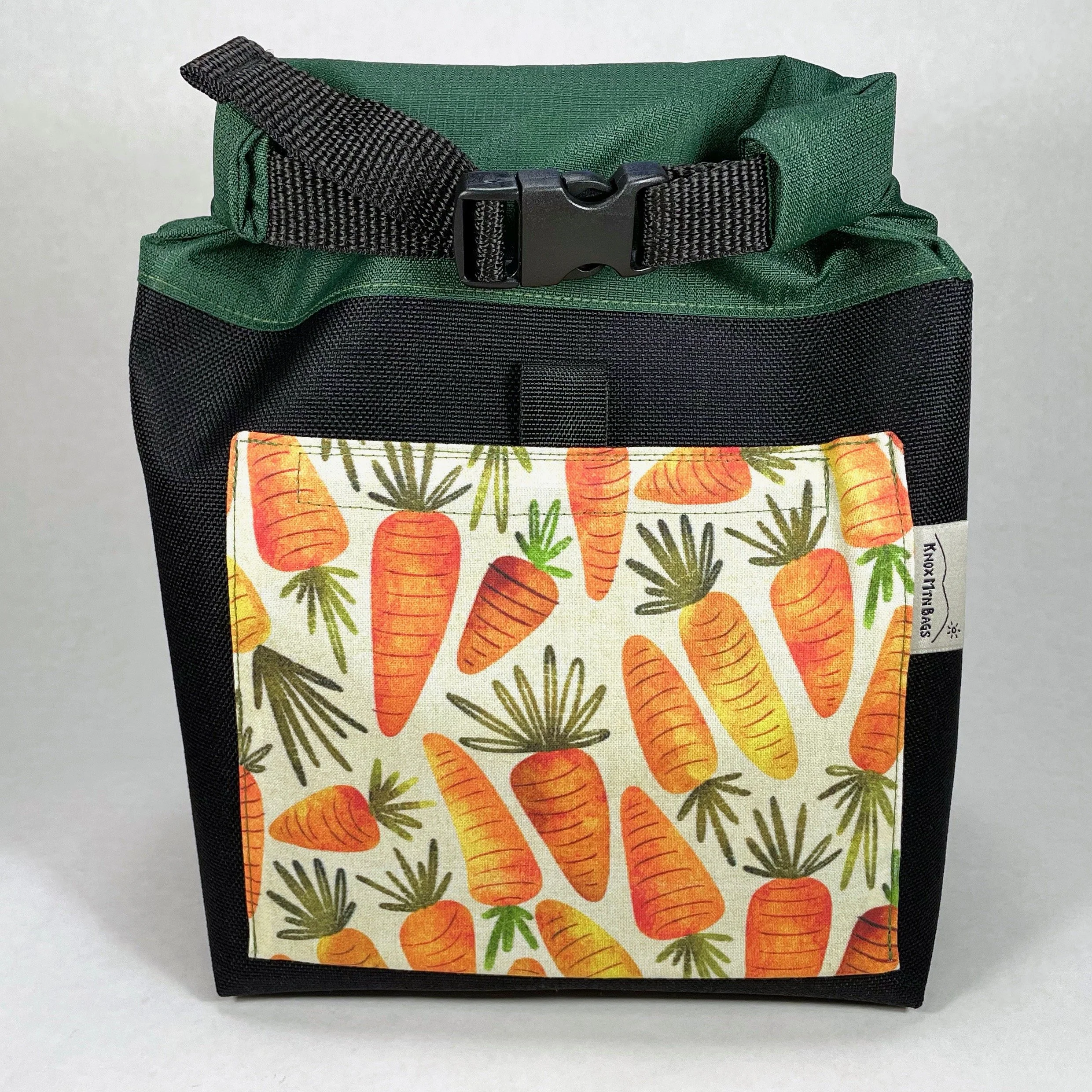 orange carrots with green roll top chalk bucket