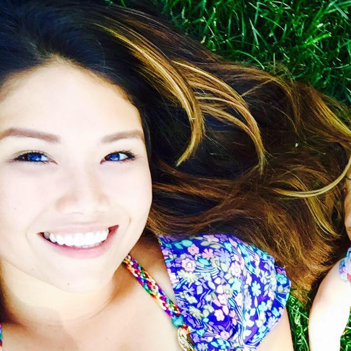 Laying on the Kentucky Blue Grass sodded lawn in her front yard on a Sunday with 8 month old baby Lily's arm. 