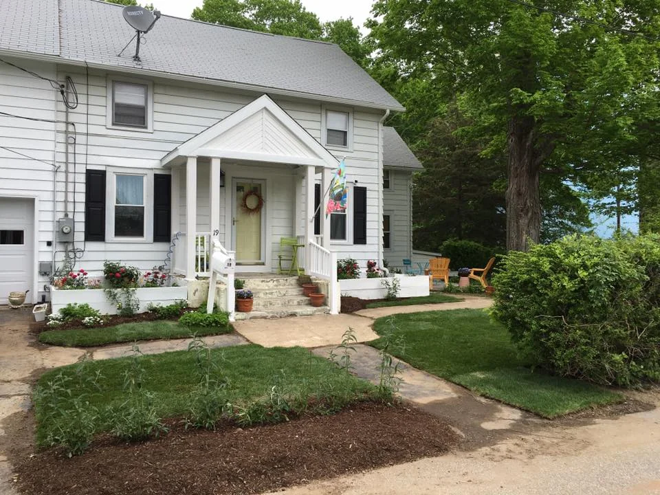  "Curb Appeal in Colchester" New Sod installation, Raised Bed Plantings, and Fresh Mulch.