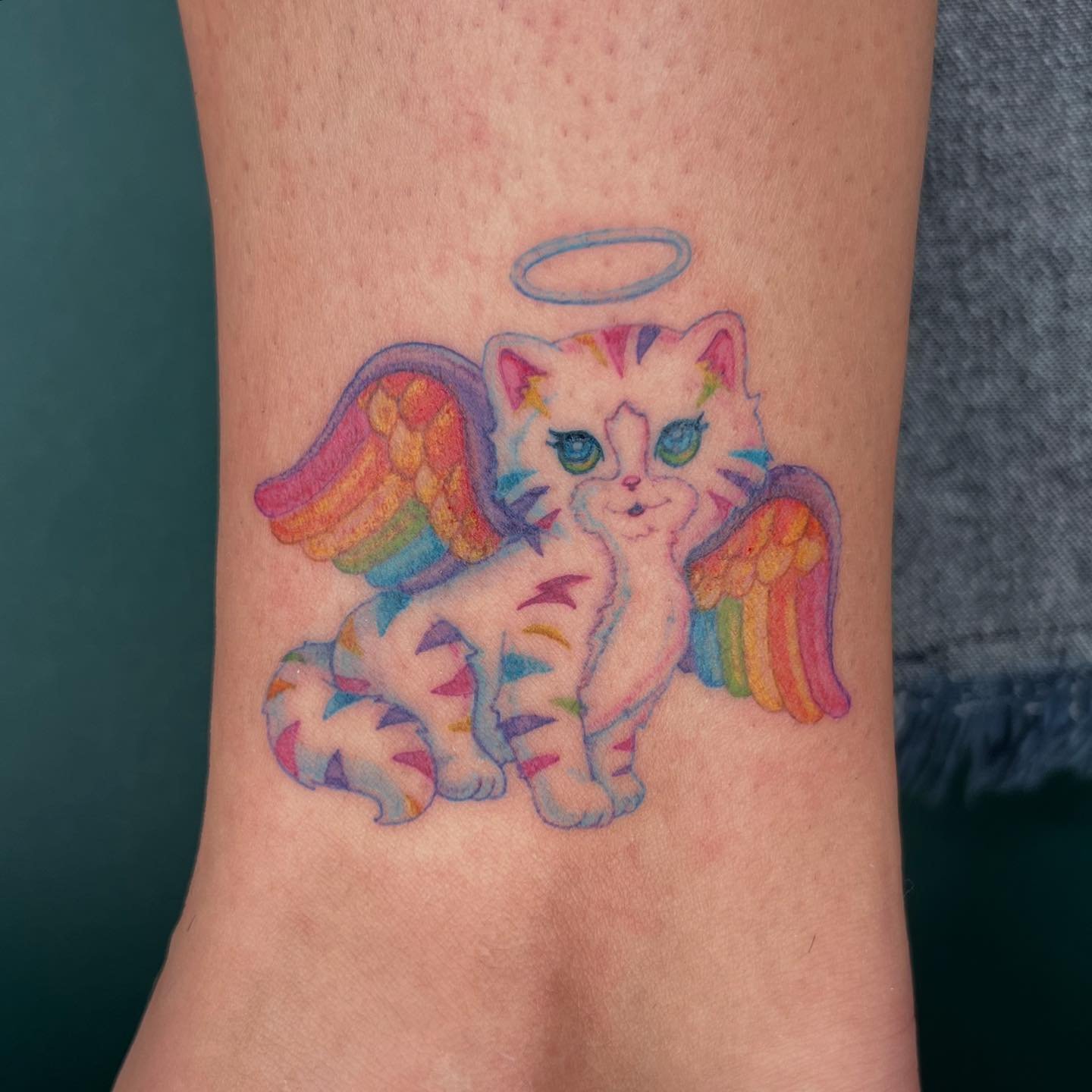 @lisafrank Rainbow Kitten Angel 🌈🐱🪽swipe for close ups, a color palette and two healed lil guys :)
Dm to book an appointment 🌈 @junkmailtattoo 
&hellip;
#lisafrank #lisafranktattoo
#tattoo #tattoonyc #flashsheet #ink #tattoos #needlework #finelin
