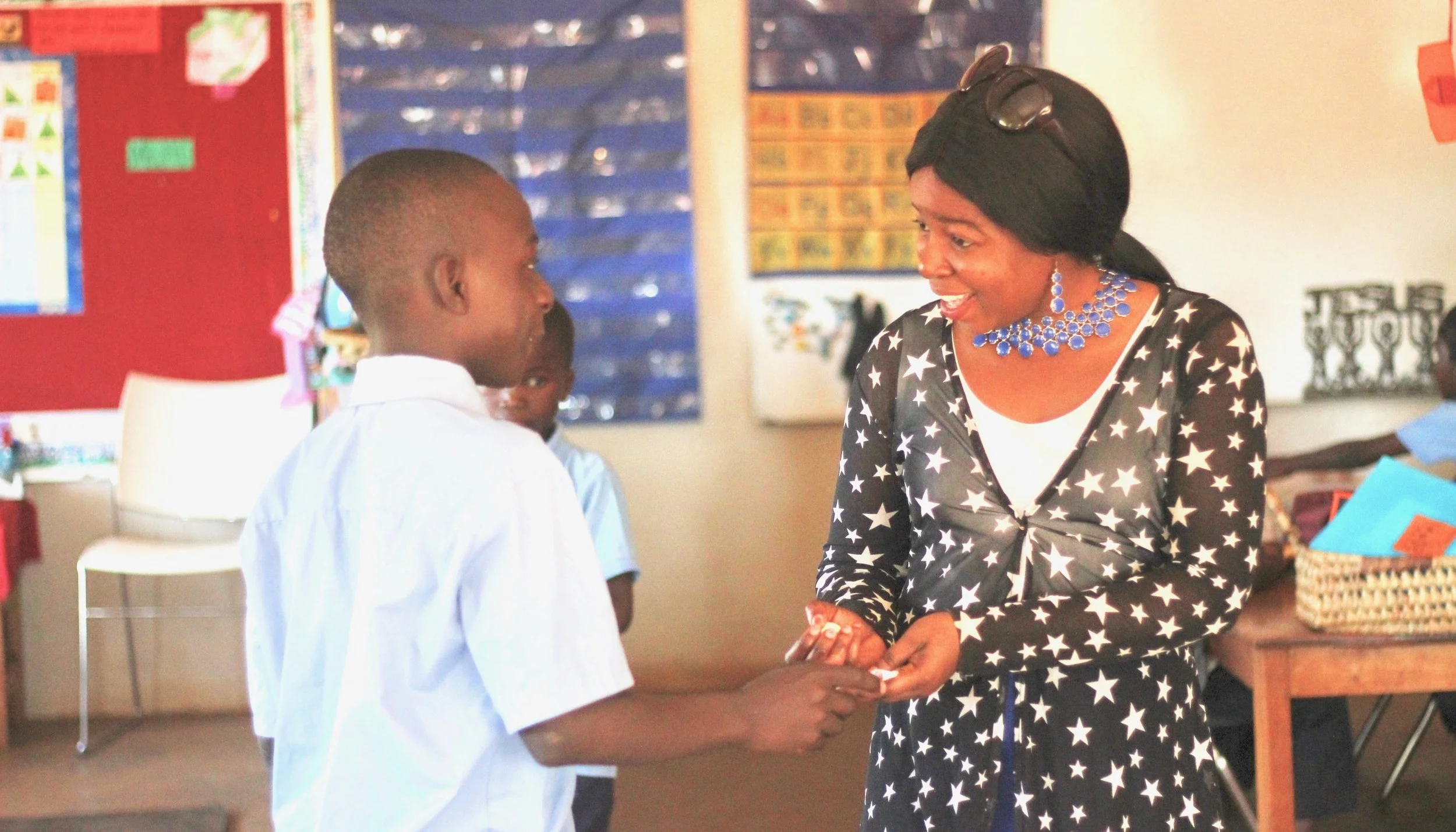 A Grade 6 student writes a thank you card for a Kindergarten teacher, thanking her for what she brings to The Esther School.