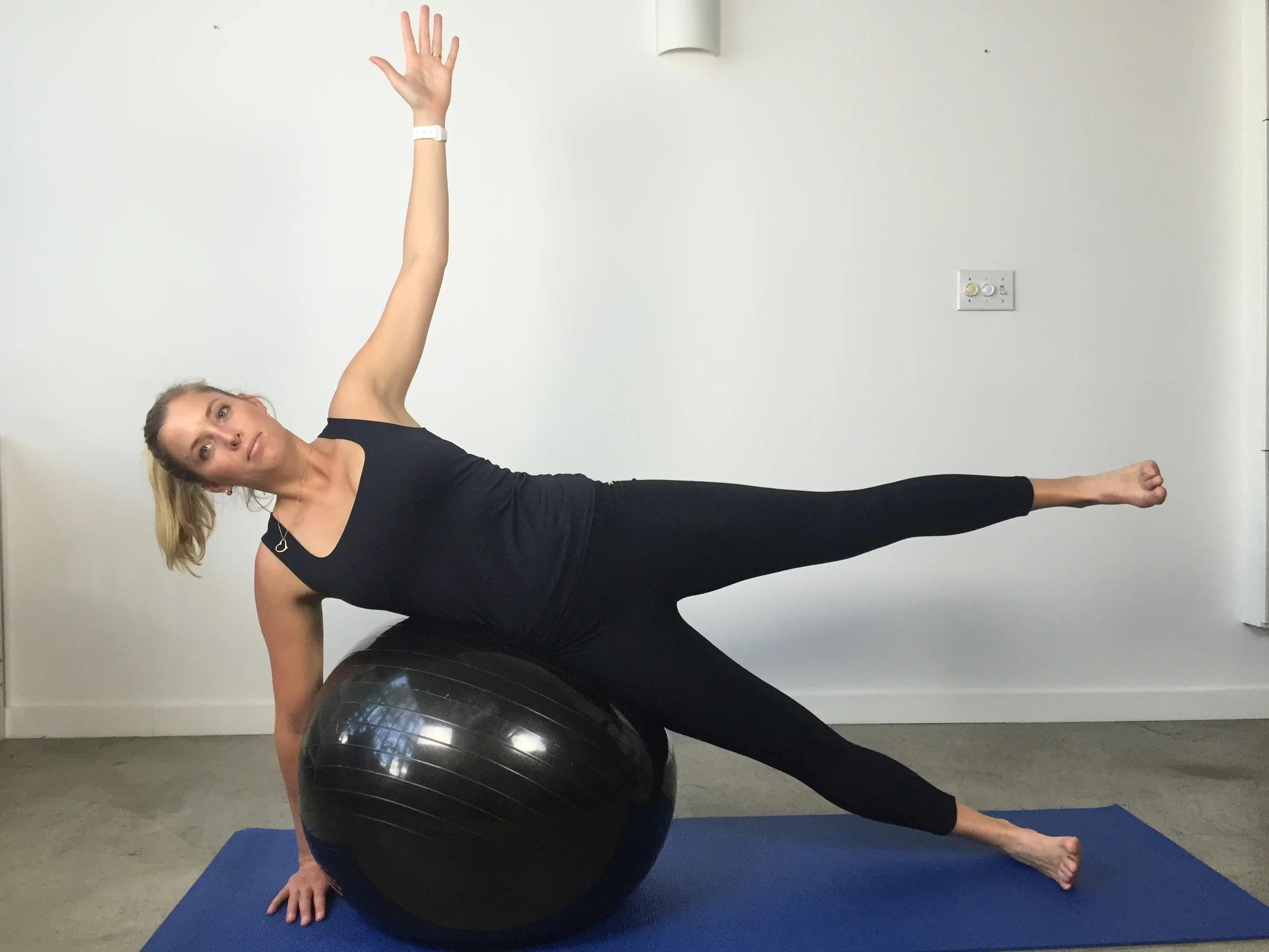 Side balance over swiss ball w leg raise