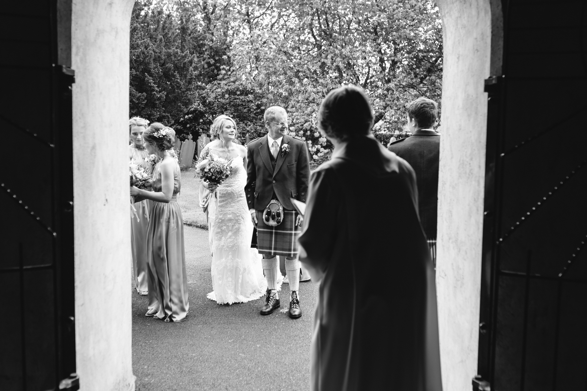 Bride waiting to enter Llanidloes church - Powys Wedding Photography