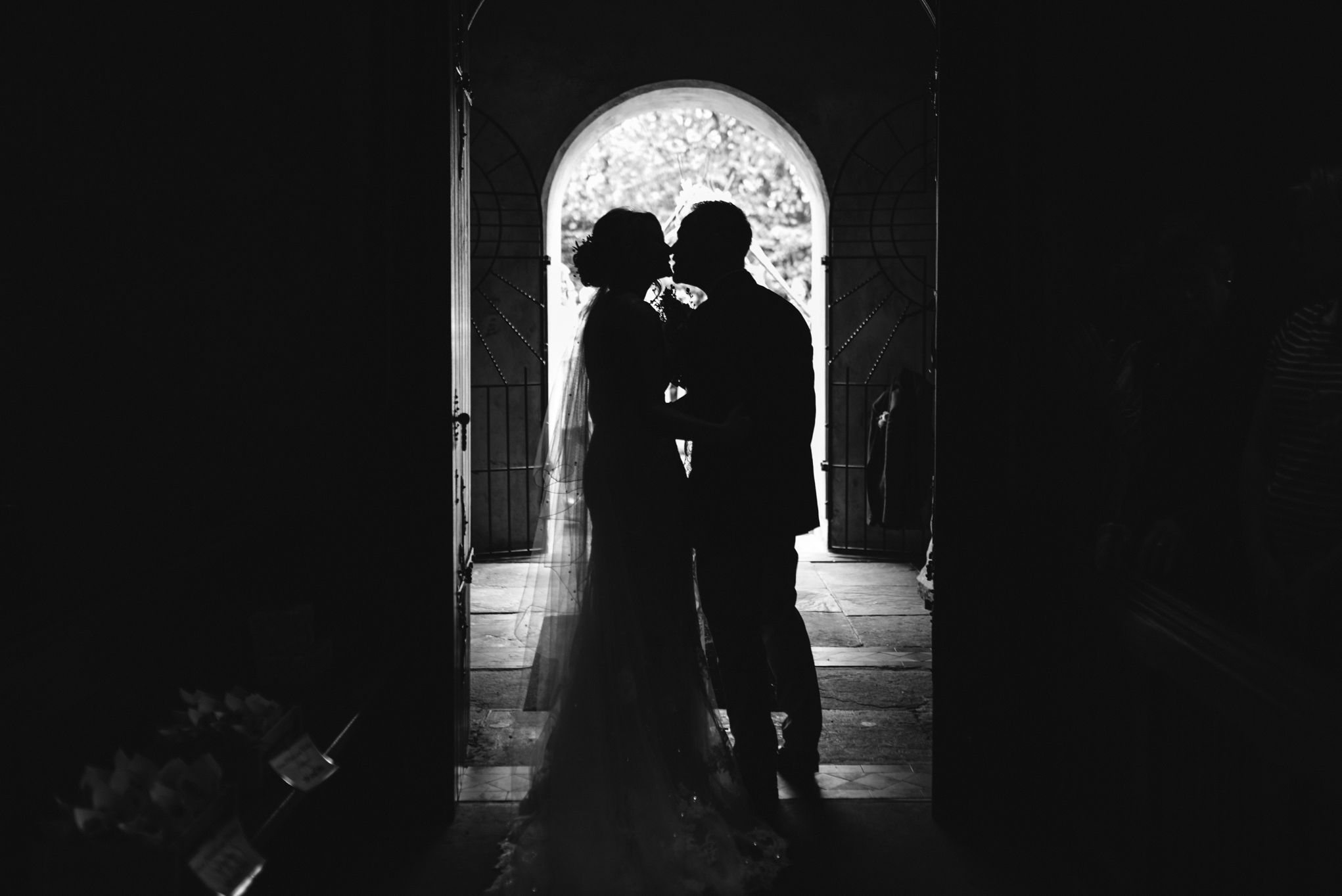 Bride and groom kiss in church door - Powys Wedding Photography