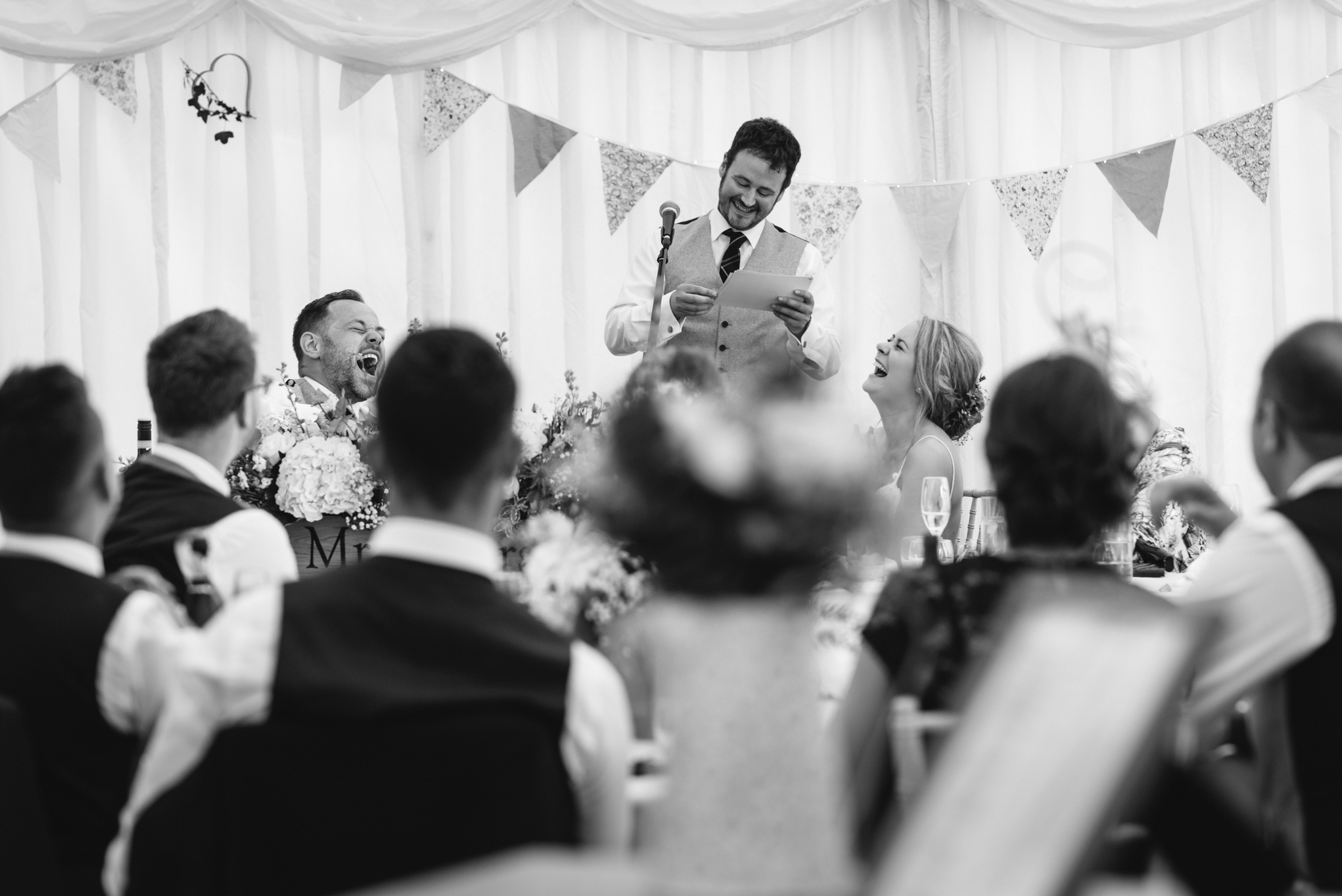 Bride and Groom laughing at best man speech - Powys Wedding Photography