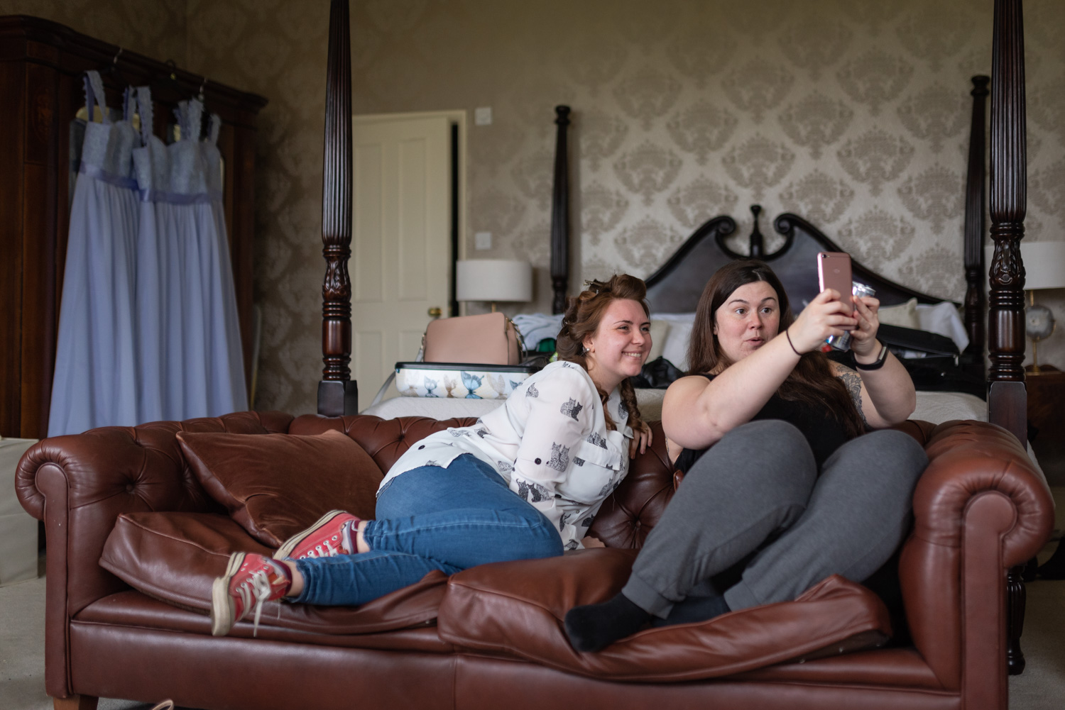 Bride and bridesmaid taking selfie