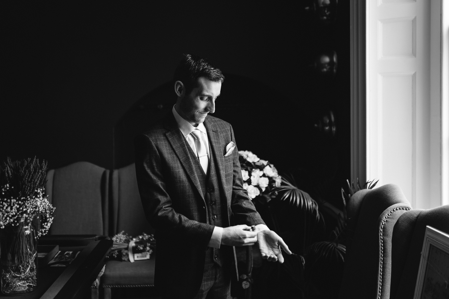Groom checking cuff links